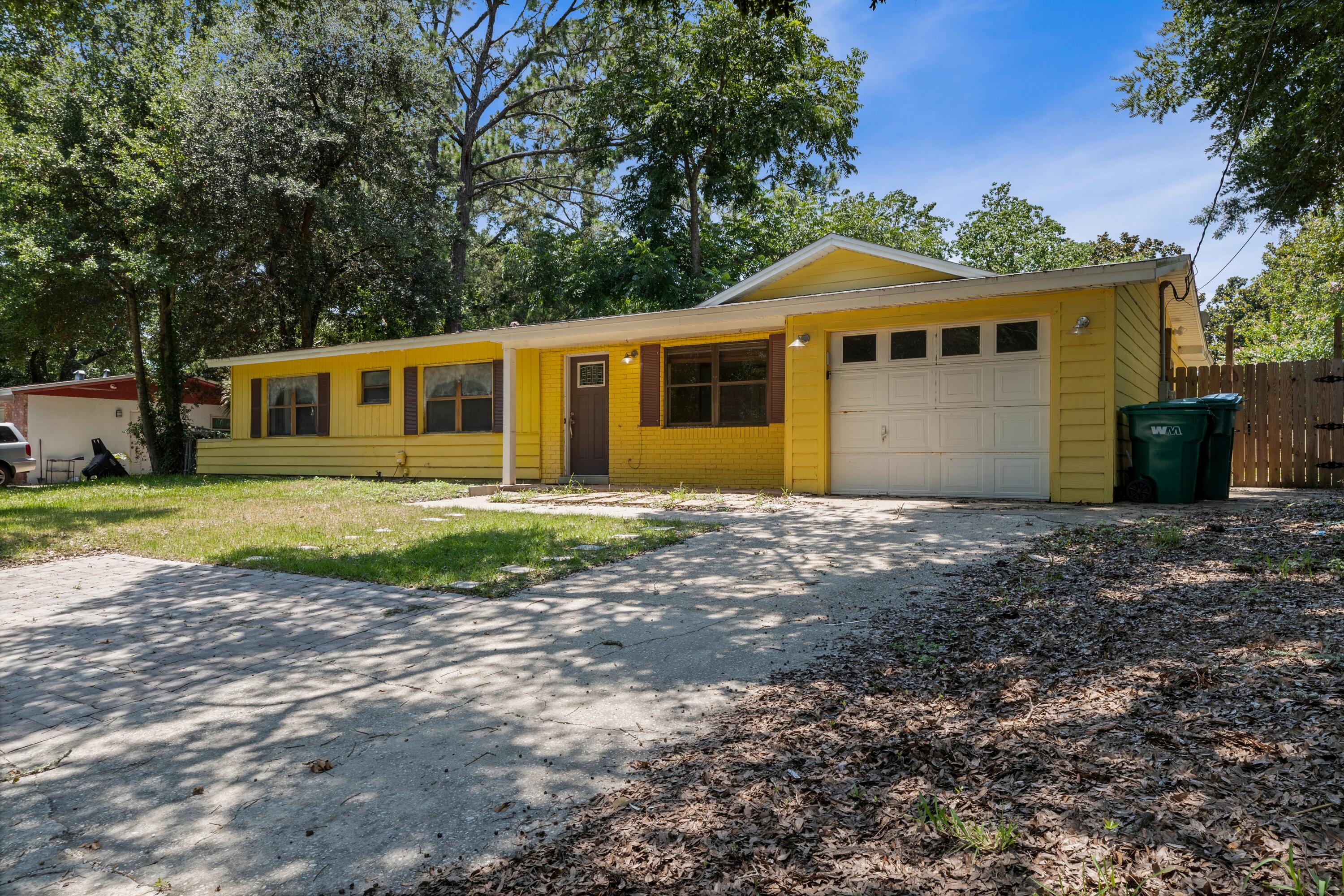 Charming 3-bedroom 2-bath tucked away in Mary Esther, ideally located for easy access to Hurlburt Field and not much farther from Eglin AFB. Spectacularly renovated kitchen gives you a head-start to realizing your personal vision of home sweet home. The spacious great room with a vintage terrazzo floor will accommodate both living and dining areas. French doors open to the Newly Installed Screened-in back patio for effortless entertaining and peace of mind from insects. There is also a newly installed awning outside of the patio to keep the ground dry so you don't drag mud into the patio! Installed systems include a 2019 HVAC and a 2017 Rinnai gas tankless water heater so you always have hot water!

The incredible kitchen features beautiful quartz counters providing plenty of working space and a breakfast bar. A contemporary tile backsplash (See More...) ...decorates all walls, even extending to the floor on one side. A stainless refrigerator, gas stove/oven and microwave, and the high-tech, two drawer dishwasher is a Fisher & Paykel. So many special features! Pull-down spice rack can be reinstalled when you move in, built-in wine rack, under-cabinet stemware rack, pull-out cubbies and drawers to organize your small items, and even a secret toe-kick storage drawer below the microwave. Every inch of potential storage space is designed for easy use.

On entering the house the first thing you'll see is the great room with 2 fans to light up and cool off the living area. Another admiring trip through the kitchen leads you to a nook perfect for breakfast or an afternoon snack, next to the large pantry with barn doors and lots of shelving. Continue on into a huge laundry room with cabinets and counters on one side, and hookups for a washer and dryer on the other. The door from the garage is right there, just a short trip to carry groceries into the kitchen.

A split floor plan arranges the primary bedroom and bath to one side of the great room, and the two bedrooms and second full bath on the other. The baths feature newer cabinets and mirrors, granite vanities, and a waterfall faucet in the hall bath. The terrazzo flooring extends through all bedrooms, with tile flooring in the baths.

Out the french doors into the backyard, enjoy your morning coffee  in the newly installed screened-in patio. Two sheds provide lots of outdoor storage and working space and a fig tree in center of the yard provides unparalleled beauty

Water lovers rejoice! Beyond a quick commute to local military bases, this home is perfectly set up for the ultimate coastal lifestyle. You'll find a dedicated paved space right next to the garage--ideal for parking your kayaks, paddleboards, or canoe. When you're ready to hit the water, choose between two nearby boat launches just minutes east on Hwy 98: the convenient ramp at Misty Water Pier or the larger facility at Liza Jackson Park. Plus, a brief drive further brings you straight to Okaloosa Island, boasting seven public beach access points to enjoy the Gulf's famous emerald waters and white sands.