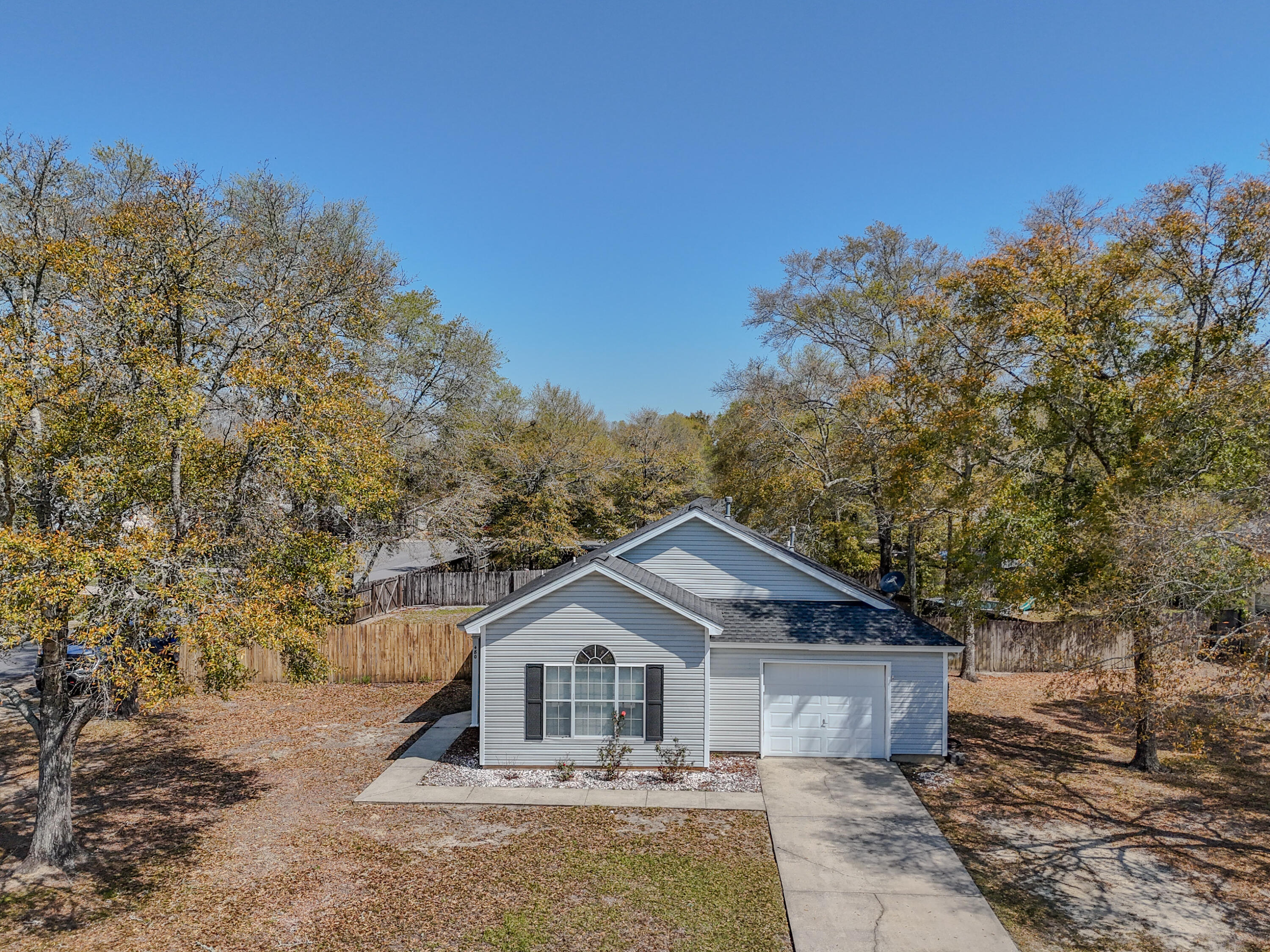 Located in the city limits, just 5 minutes from downtown DeFuniak Springs, this 3 bed/2 bath home has had most major updates done, to include the roof in 2019. The split floor plan has the living room open to the large, eat-in kitchen, which opens up to this amazingly massive 20x22 covered back porch! Finding a home this size, WITH a garage, huge porch, on a corner lot, fenced 1/3 acre in town, is not an easy feat. The kitchen is equipped with a gas range for cooking and room for an island or dining table. The back yard is privacy fenced with some large oaks for shade.  Bonus: it's walking distance to Lake Stanley Park, where you can bring your boat for skiing, inner tubes, and jet skis. Schools, additional parks and shopping are all convenient. Qualifies for all types of financing.
