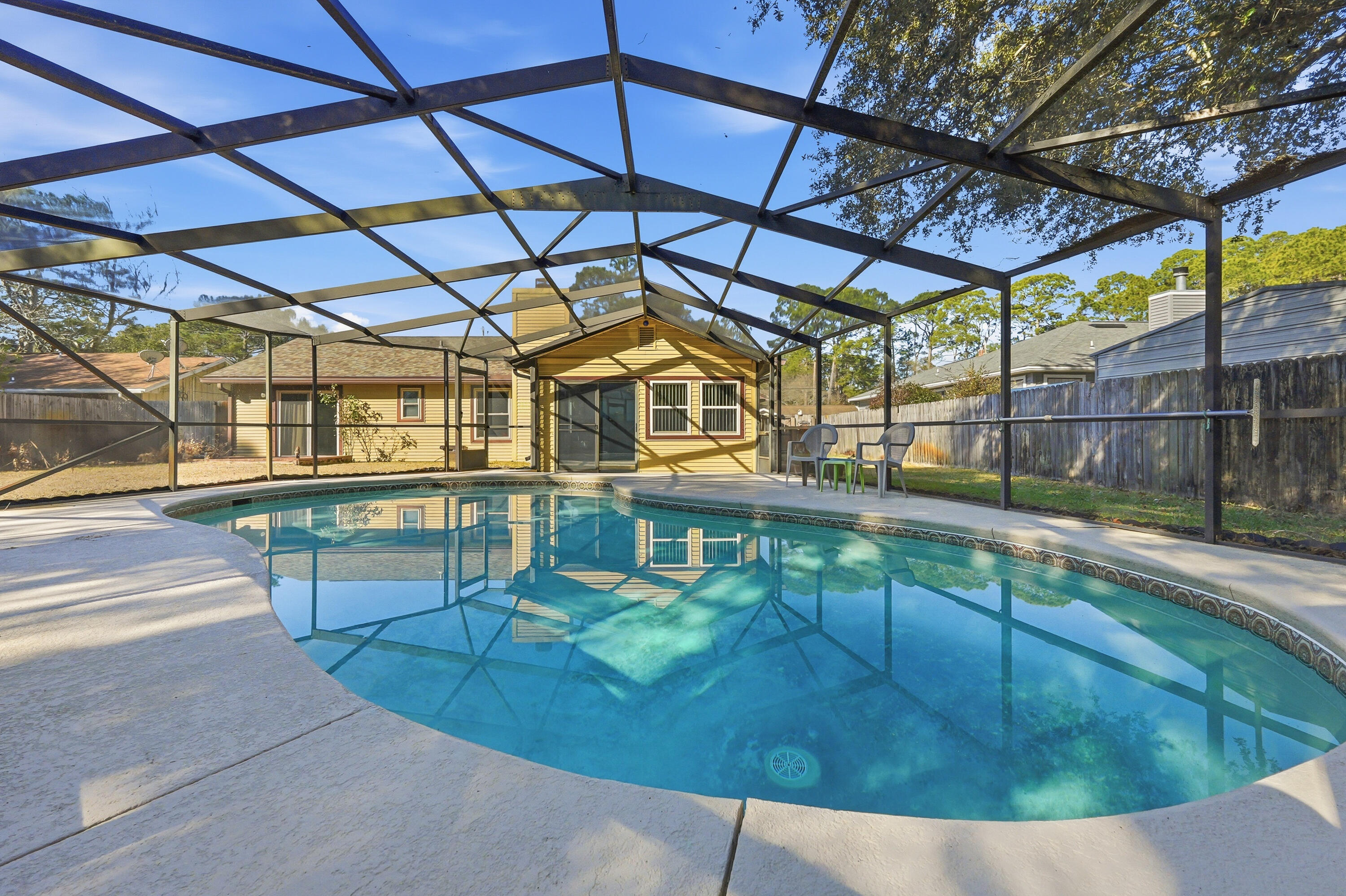 This well-maintained home offers a functional and inviting layout featuring luxury vinyl plank flooring in the main living area and a cozy wood-burning fireplace as the focal point of the living room. The kitchen is equipped with granite countertops and ample workspace, ideal for everyday living and entertaining. A finished Florida room adds valuable living space and is perfect for relaxing or hosting guests year-round. Step outside to enjoy the screened-in gunite pool, offering privacy and the perfect setting for outdoor living and entertaining. A great combination of comfort, durability, and versatile living spaces.
