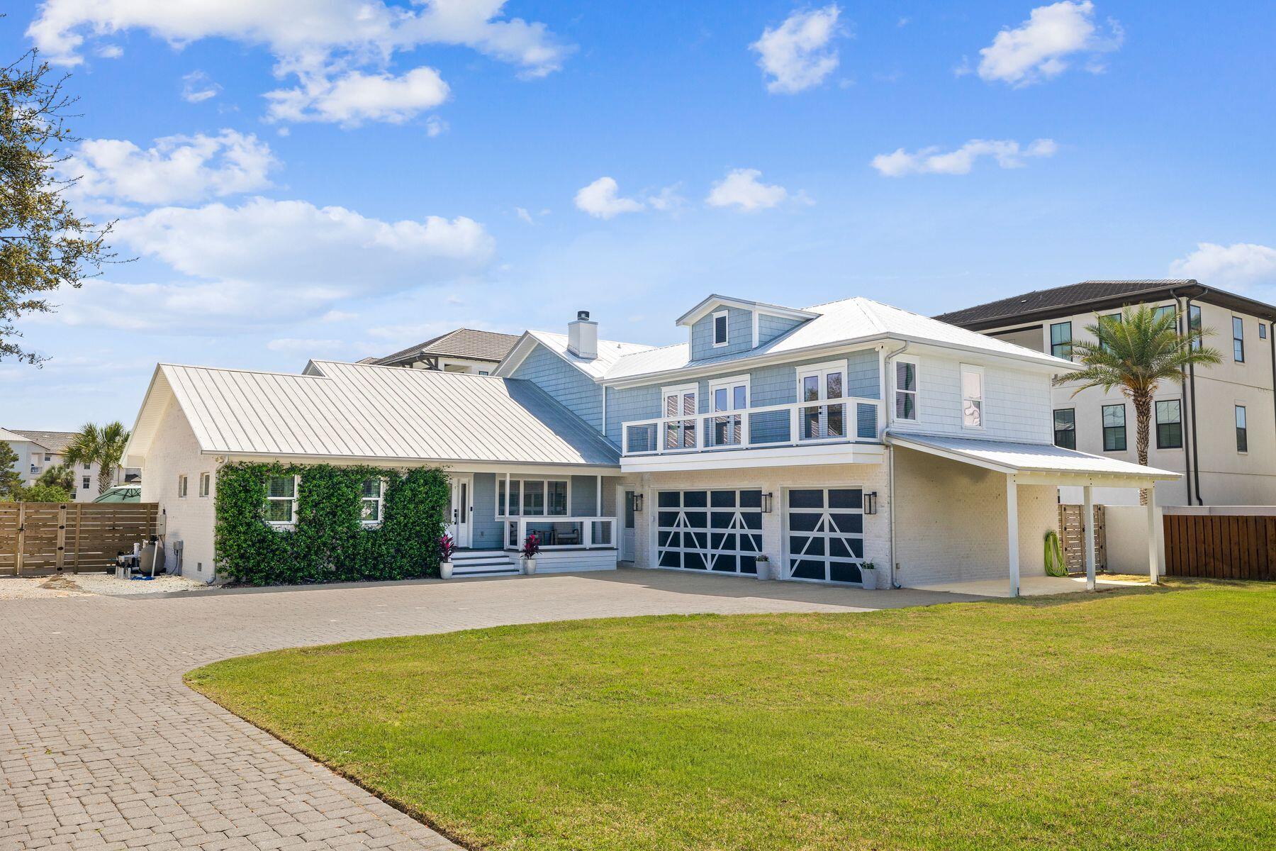 Situated just three blocks from the sand, 40 Louva Lane occupies a rare 0.50-acre parcel just above Gulf Place, making dining, shopping, and beach access within easy walking distance. This lot size is incredibly hard to find in this corridor, particularly with no HOA and no restrictions. 

The home sits toward the back of the site, giving a feeling of privacy and seclusion. A long brick paver driveway leads to the courtyard entry and offers ample parking. 

In total, the home offers 2,703 square feet, four bedrooms, three-and-a-half bathrooms, multiple porches, a resort-style pool, a 3.5-car garage, and a carport. The fully landscaped front and back yards, including podocarpus, jasmine vines, palms, palmettos, and lots of sod, create a true oasis. Gas lanterns line the garage and the front and rear porches have wood-paneled ceilings. 

The exterior was converted from stucco to Hardie Board and brick during the 2019-2020 renovation, a full-scale remodel that touched virtually every surface, system, and finish inside and outside the home. 

Inside, a welcoming foyer connects the living, dining, kitchen, and bar areas designed for both everyday living and effortless entertaining. The bar is equipped with an ice maker, wine fridge, and glass-paneled cabinets. The kitchen features a gas range. All appliances, cabinetry, countertops, and backsplash were replaced in the renovation. A wood-burning fireplace with a custom pecky cypress mantel anchors the living room, and shiplap accents throughout the home reinforce the coastal character. 

The primary suite is on the main level and features an ensuite bath and dual closets. The half bath and laundry are also on the first floor, creating a true single-story living experience, leaving the upstairs as a guest space.

Upstairs, the second living room and game area serve as another large gathering space, with access to a balcony overlooking the front yard. The sleeping quarters are smartly arranged: two bedrooms share a Jack-and-Jill bath, while a third bedroom and bunkroom share a hall bath. 

Mechanically, the home was rebuilt from the inside out. Spray foam insulation was installed throughout the walls and attic; all windows and doors were replaced; the majority of the sheetrock was replaced; and all flooring, lighting, and plumbing fixtures were replaced. 

The backyard delivers on every level. Enclosed by a six-foot concrete privacy fence, the outdoor living space centers on a pool with a sun shelf, splash pad, integrated hot tub with spillover, and a built-in basketball hoop, all surrounded by white natural stone pavers and palms. The rear screened porch was expanded to double its original size during the renovation and features motorized screens that open the porch to the yard and pool. 

Lastly, the three-and-a-half car garage is deep enough for your Suburban and offers all the additional storage you could imagine. Fully furnished and genuinely turnkey, 40 Louva Lane is the rare property that delivers the quintessential beach home you've been looking for.
2000 Year Built is based on Walton County PA Effective Year Built
