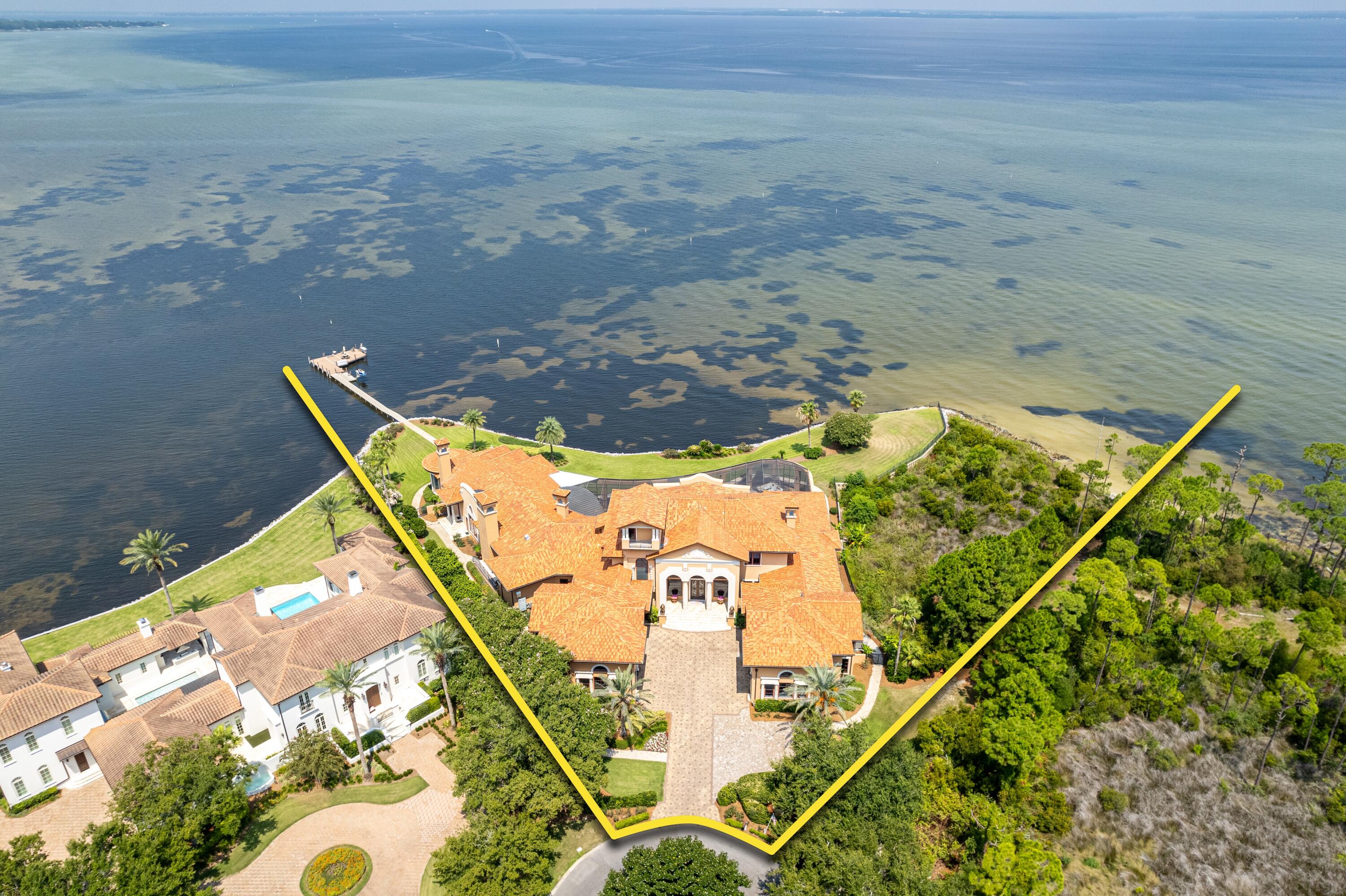 SPECTACULAR WATERFRONT ESTATE featured on HGTV'S EXTREME HOMES! Welcome to 4300 Breakwater Drive, Destin, Florida's Most Prestigious Waterfront Estate located within the exclusive Waterford of Kelly Plantation; a gated enclave within a gated master-planned community that offers a pristine golf course, club house with restaurant, tennis, and new pickleball courts! This magnificent home displays a fabulous Tuscan style and exquisite features and finishes throughout. Oriented on indisputably the finest bay-front acreage in all of Destin, the sprawling 1.8-acre estate contains over 400' of water frontage on the Choctawhatchee Bay and Jones Bayou, and a brick-paved path to the boat dock. Custom built using the finest of materials and technology, this estate reflects elegance and... sophistication. A brick-paved motor court leads to the dramatic arched limestone entrance, flanked by two lion sculptures and iron Cantera doors. The grand foyer has dual stairways, each with hand railings complementing the styling of the front doors and allows for direct views through to the expansive pool pavilion with the ultimate backdrop: the serene Choctawhatchee Bay waters! The first level features an open, inviting floor plan that is perfect for entertaining family and guests. A formal living and formal dining room flank the grand foyer. The dining room opens to a large wet bar with commercial grade 3' x 5' walk-in cooler and the family/casual dining area/kitchen. A circular floor-to-ceiling aquarium is just one mesmerizing focal point of this grand space. The gourmet kitchen would please the fussiest cook, with plenty of custom cabinetry, professional-grade appliances, and double-stacked granite counters. Just beyond the family room and visible from the kitchen is the home theater room, featuring stadium seating and 113' wide screen. The luxurious master wing has a large bedroom with three televisions mounted to the ceiling over the bed, a waterfront sitting area, a fireplace, a sumptuous designer bathtub, a large walk-in shower, double vanities, and two walk-in closets. Two additional bedroom suites are on the first level, as well as an exercise room. Take the stairs or the elevator to the second level to find three additional bedroom suites, a wet bar and adjoining den, a massage room, a large storage room, two offices with a private entrance, and a large balcony overlooking the bay and pool area. Step outside on the first level to a tropical oasis, with a beach-entry pool, a fountain with swim-up bar, and a lanai with summer kitchen and fireplace. Stacking sliding glass doors open from the family room, formal dining room, and living room onto the lanai, expanding the living and entertaining space. There are two garages, each accommodate three cars. In addition to the main house, a guest house over the north garage has two bedrooms, a full kitchen and living area, and a private entrance. So much thought went into every detail of this magnificent home! Every aspect of this interior has been finely appointed throughout with ruffled stone floors, Alder doors, hardwood floors, intricate trayed and domed ceilings. Also includes conditioned pet rooms with pet doors; a commercial-grade sprinkler system; a geo-thermal heating and cooling system; smart house technology, and much more! This expansive waterfront point at the end of Waterford's private cul-de-sac features lush landscaping, as well as a boat dock. A new whole-house generator was installed in 2024! A property of this caliber is a rarity and will certainly be admired by discriminating ownership that demands the finest details! Please inquire for further details and to schedule a private showing.