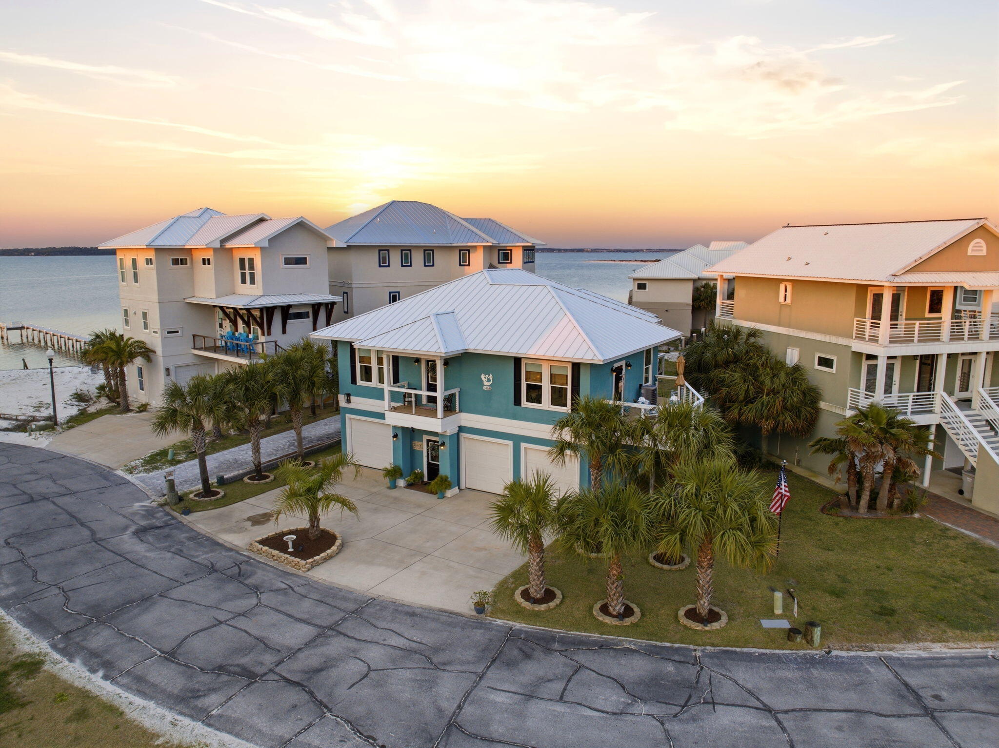 NOW COMES FULLY FURNISHED! Summer is here! MOVE IN READY! 

Welcome to Your Private Coastal Sanctuary in Caribbean Isle on Navarre Beach

From the moment you enter the exclusive, gated community of Caribbean Isle, you're transported into a true tropical paradise--complete with winding roads, vibrant coastal architecture, underground utilities, streetlights, and resort-style amenities including a community pool and tennis courts.

Perfectly positioned in one of the most desirable locations within the neighborhood, this custom-built, one-owner beach home offers the ultimate blend of privacy, convenience, and luxury. Just steps from your back door, you'll find direct access to the sugar-white sands and emerald waters of the beach. Enjoy peaceful morning strolls along the quiet shoreline, or head just across the street to experience the energy of Gulf. Designed for Coastal Living & Entertaining

This thoughtfully designed residence features four spacious sleeping areas, including a custom bunk room with built-in beds and storage--perfect for hosting family and guests. Every inch of this home reflects intentional design and elevated coastal style.

The main living spaces are pouring with natural light, enhanced by expansive windows and three generous porches that capture both sunrise and sunset views. With water views from nearly every angle, the connection to the coast is felt throughout the home.

The chef's kitchen is a true showpiece, featuring ceiling-height light blue cabinetry, upgraded countertops, designer sconce lighting, and an open layout ideal for entertaining.

Exceptional Features Inside & Out

Impact-rated glass for enhanced durability and lower insurance costs

Luxury vinyl plank flooring with a soft driftwood finish

Custom cable railing on decks for unobstructed water views

Metal roof for long-term durability

Deep soaking tub and designer tile shower in the primary suite

Abundant storage throughout, including a space designed for a future elevator (plans available upon request)

Ground Level Coastal Retreat

The lower level offers an incredible flex space--ideal for a den, game room, or "man cave"--featuring a unique glass garage door that allows natural light to pour in while maintaining privacy. Just outside, a private outdoor shower provides the perfect spot to rinse off after a day at the beach. (This was not added into the upstairs square footage.) 

With over 1,600 square feet of garage space, there's ample room for multiple vehicles, golf carts, and all your beach and boating gear.

Outdoor Living at Its Finest

The professionally enhanced landscaping, complete with multiple palm trees, perfectly frames the home and enhances its tropical curb appeal. Every outdoor space invites relaxation, from breezy porches to shaded areas below.

Additional Highlights

Located in the gated community of Caribbean Isle

Low HOA: $485/quarter

Flood Insurance: ~$996/year

Homeowners Insurance: ~$3,700/year

Furniture negotiable with acceptable offer

This meticulously maintained home offers not just a residence, but a lifestyle--where every day feels like a vacation.

Experience the beauty, comfort, and luxury of Navarre Beach living in Caribbean Isle. Schedule your private showing today. The community has an annual Road Reserve of $300.00 in addition to annual HOA dues. Buyer to verify all information deemed important to buyer including but not limited to lot size, room measurements, etc. prior to closing