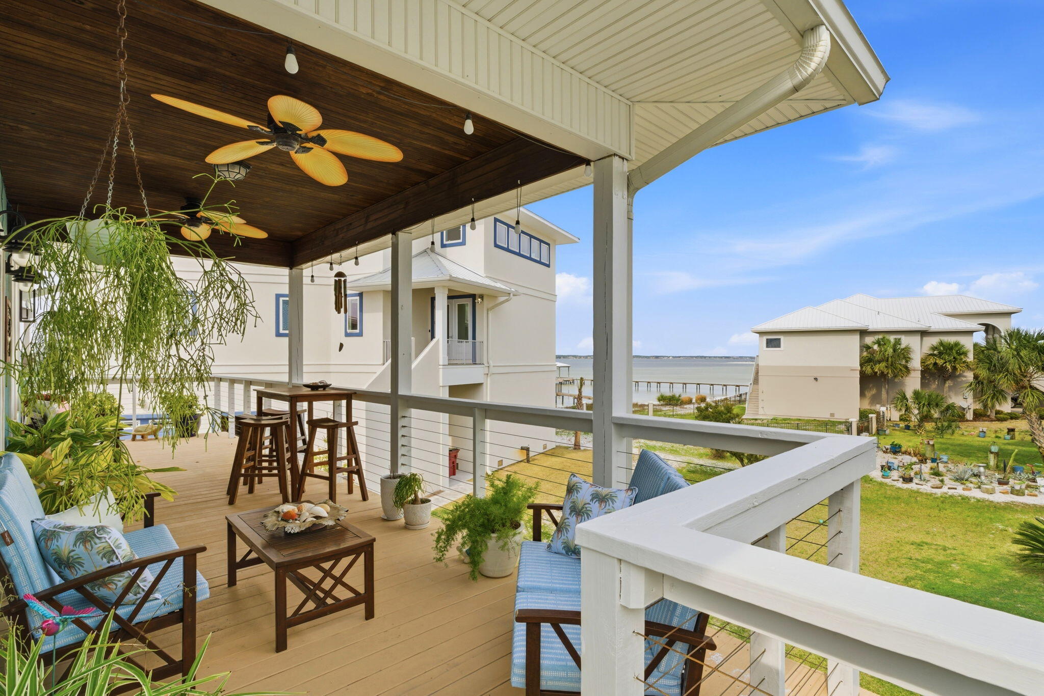 Welcome to Your Private Coastal Sanctuary in Caribbean Isle on Navarre Beach

From the moment you enter the exclusive, gated community of Caribbean Isle, you're transported into a true tropical paradise--complete with winding roads, vibrant coastal architecture, underground utilities, streetlights, and resort-style amenities including a community pool and tennis courts.

Perfectly positioned in one of the most desirable locations within the neighborhood, this custom-built, one-owner beach home offers the ultimate blend of privacy, convenience, and luxury. Just steps from your back door, you'll find direct access to the sugar-white sands and emerald waters of the beach. Enjoy peaceful morning strolls along the quiet shoreline, or head just across the street to experience the energy of Gulf. Designed for Coastal Living & Entertaining

This thoughtfully designed residence features four spacious sleeping areas, including a custom bunk room with built-in beds and storage--perfect for hosting family and guests. Every inch of this home reflects intentional design and elevated coastal style.

The main living spaces are pouring with natural light, enhanced by expansive windows and three generous porches that capture both sunrise and sunset views. With water views from nearly every angle, the connection to the coast is felt throughout the home.

The chef's kitchen is a true showpiece, featuring ceiling-height light blue cabinetry, upgraded countertops, designer sconce lighting, and an open layout ideal for entertaining.

Exceptional Features Inside & Out

Impact-rated glass for enhanced durability and lower insurance costs

Luxury vinyl plank flooring with a soft driftwood finish

Custom cable railing on decks for unobstructed water views

Metal roof for long-term durability

Deep soaking tub and designer tile shower in the primary suite

Abundant storage throughout, including a space designed for a future elevator (plans available upon request)

Ground Level Coastal Retreat

The lower level offers an incredible flex space--ideal for a den, game room, or "man cave"--featuring a unique glass garage door that allows natural light to pour in while maintaining privacy. Just outside, a private outdoor shower provides the perfect spot to rinse off after a day at the beach. (This was not added into the upstairs square footage.) 

With over 1,600 square feet of garage space, there's ample room for multiple vehicles, golf carts, and all your beach and boating gear.

Outdoor Living at Its Finest

The professionally enhanced landscaping, complete with multiple palm trees, perfectly frames the home and enhances its tropical curb appeal. Every outdoor space invites relaxation, from breezy porches to shaded areas below.

Additional Highlights

Located in the gated community of Caribbean Isle

Low HOA: $485/quarter

Flood Insurance: ~$996/year

Homeowners Insurance: ~$3,700/year

Furniture negotiable with acceptable offer

This meticulously maintained home offers not just a residence, but a lifestyle--where every day feels like a vacation.

Experience the beauty, comfort, and luxury of Navarre Beach living in Caribbean Isle. Schedule your private showing today. The community has an annual Road Reserve of $300.00 in addition to annual HOA dues. Buyer to verify all information deemed important to buyer including but not limited to lot size, room measurements, etc. prior to closing