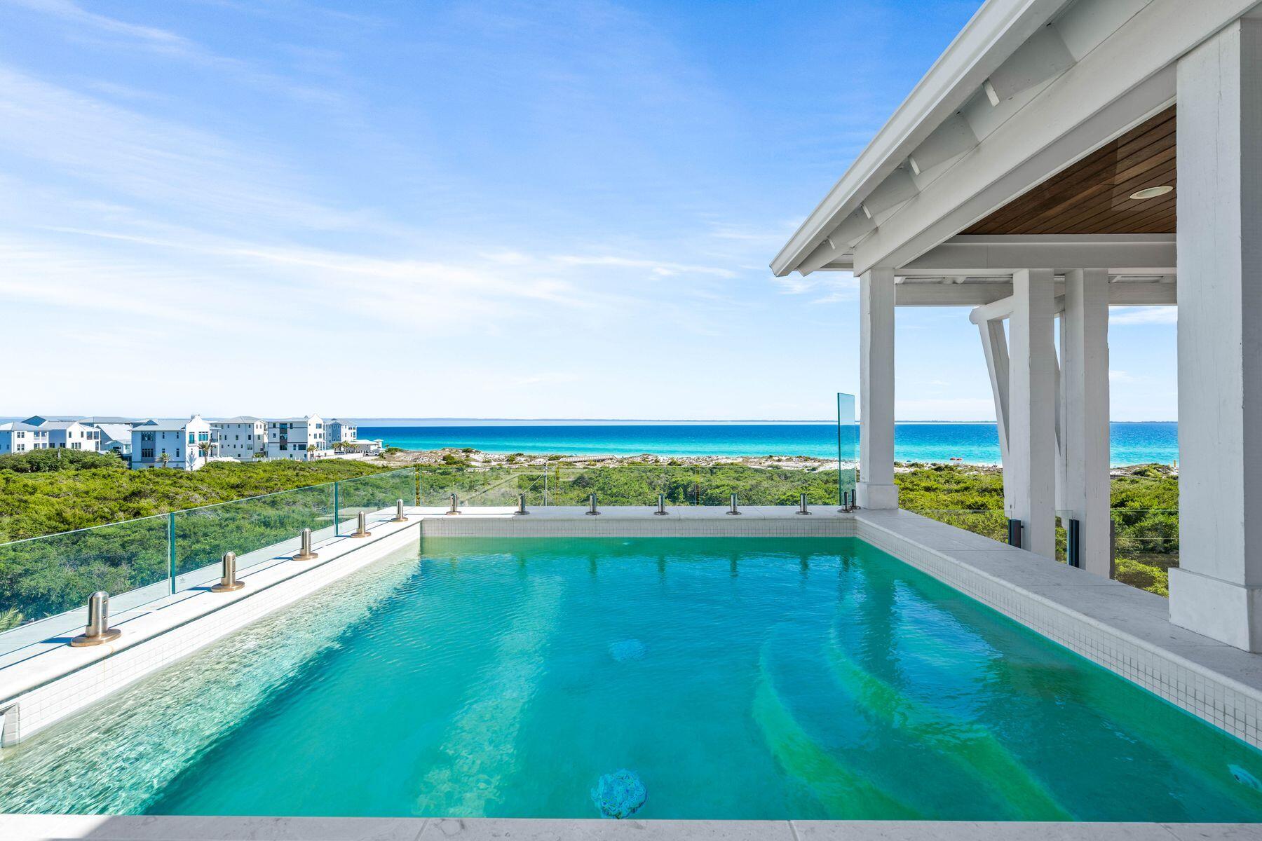 This exceptional four-level custom home in the Mala Beach community offers FOREVER Gulf views and a standard of construction rarely seen along the Emerald Coast.
Spanning 5,204 square feet, the home features an elevator servicing all levels. It includes four spacious king primary suites and two bunk bedrooms. The entryway leads the experience with a soaring Venetian plaster foyer and raised ceilings that lead into a large open living area with Peacock paver floors and floor-to-ceiling Jeldwen windows. A king bedroom features dual vanities and curated marble countertops. A marble wet bar with sink and refrigerator, powder bath, laundry, and an attached garage currently outfitted as a game room complete this level.
The second floor houses one king primary suite with a stunning marble bathroom featuring a freestanding soaking tub, rainhead shower, and floating vanities. Additionally, there are two generously sized bunk bedrooms each with a dedicated bathroom featuring a large walk-in shower.  The bunk bedrooms accommodate ten guests across three single bunks and one full-sized bunk per room which is the perfect spot for the kids to hang out. 
The third floor provides two additional king primary suites, both with direct access to a balcony that offers breathtaking Gulf views. The large ensuite baths are equally impressive, featuring freestanding tubs, marble tile floors and showers, and floating dual vanities. A second laundry is also located on this level. The fourth floor of this residence offers unparalleled Gulf views from every angle. A dramatic vaulted ceiling seamlessly integrates the living, dining, and kitchen spaces. The chef's kitchen stands as a culinary masterpiece, featuring a handcrafted La Cornue range, a paneled SubZero refrigerator, Italian-made cabinetry, and honed marble countertops, complemented by a stunning full-wall backsplash. The powder bath is accentuated by a sculptural pedestal sink and handcrafted full tile wall. Euro Wall sliding doors provide access to the rooftop deck, which includes a heated pool that you will never want to leave with majestic Gulf views. The home boasts over 800 square feet of outdoor living space for year-round enjoyment.

This remarkable retreat is a must-see for the discerning buyer seeking the ultimate blend of serenity, style, and coastal charm. The absence of development in front of the property ensures that the Gulf views will be endlessly cherished.  Conveniently located just steps from one of Walton County's premier beach accesses and minutes away from Alys Beach, Rosemary Beach, 30Avenue, and the vibrant shopping and dining options that the Emerald Coast offers.