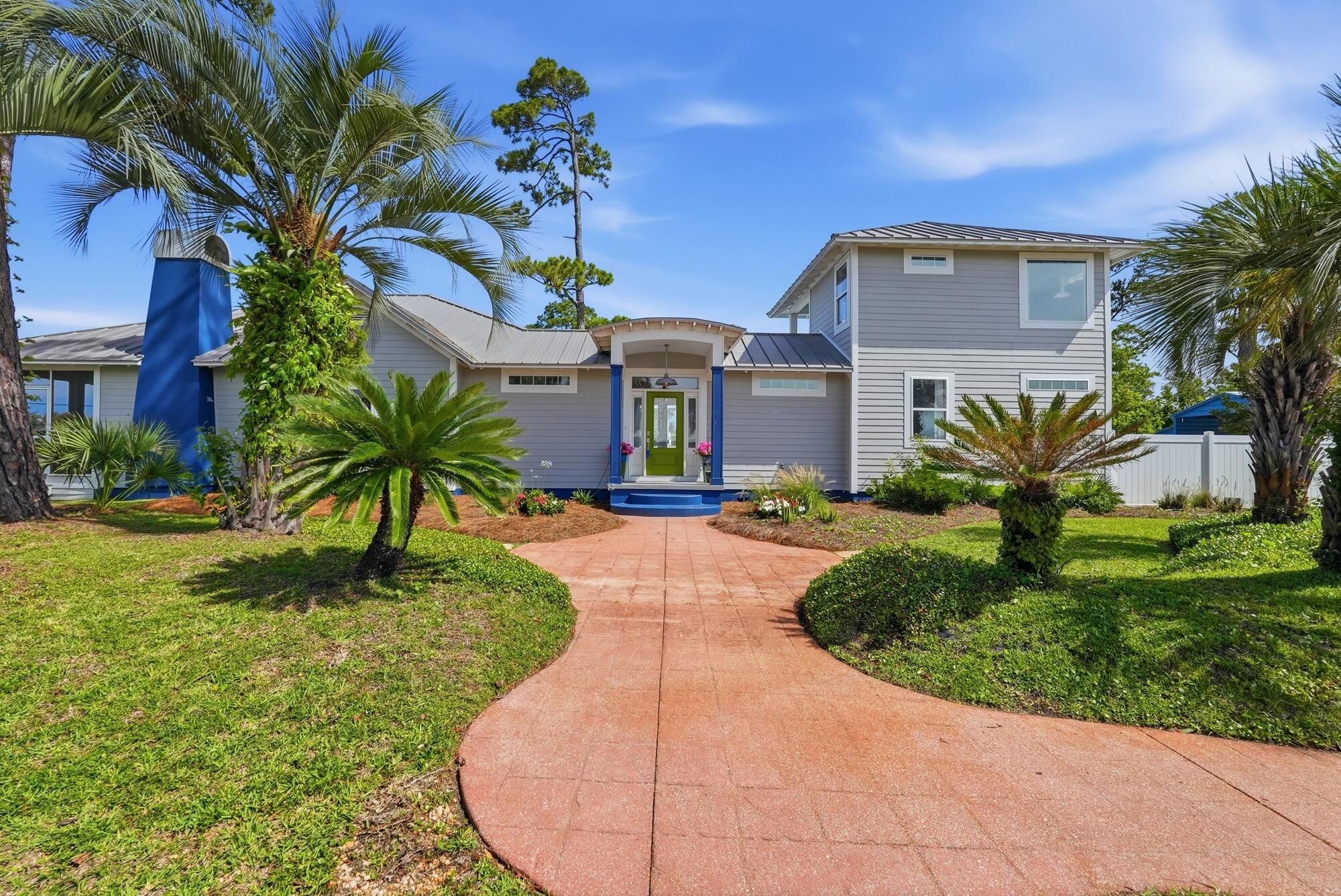 Welcome to this beautifully updated coastal home in the heart of Port St. Joe. Offering 4 bedrooms, 3 bathrooms, and 2,276 square feet, this exceptional property is located just one block from St. Joseph Bay and minutes from downtown, combining modern comfort with the relaxed lifestyle of Florida's Forgotten Coast. Inside, you'll find a bright, open-concept floor plan featuring custom built-ins, luxury finishes, wide-plank flooring, and abundant natural light. The spacious kitchen is designed for both everyday living and entertaining, with custom cabinetry, granite countertops, stainless steel appliances, a large center island, and ample storage. The adjoining living and dining areas create an inviting space for gathering with family and friends. The split-bedroom layout provides privacy and functionality. The primary suite features a large custom walk-in closet and a beautifully appointed bath with designer tilework, a soaking tub, and a walk-in shower. Three additional bedrooms and two updated guest baths offer comfortable accommodations for family and visitors. Outdoor living is equally impressive. Relax on the expansive covered and screened front porch while enjoying refreshing bay views and breezes. The large private backyard retreat features a sparkling in-ground pool, spacious pool deck, privacy fencing, and a covered patio perfect for outdoor dining, entertaining, or unwinding after a day on the water. Situated on two beautifully landscaped corner lots with rear alley access, mature palms, native plantings, this home offers outstanding curb appeal and a true coastal atmosphere. Enjoy convenient golf cart friendly access that is less than a mile to downtown Port St. Joe's shops, restaurants, marina, and waterfront parks. Cape San Blas and St. Joe Beach are just a short drive away. Whether you're searching for a primary residence, vacation home, or investment property, this coastal retreat offers an exceptional location and lifestyle.