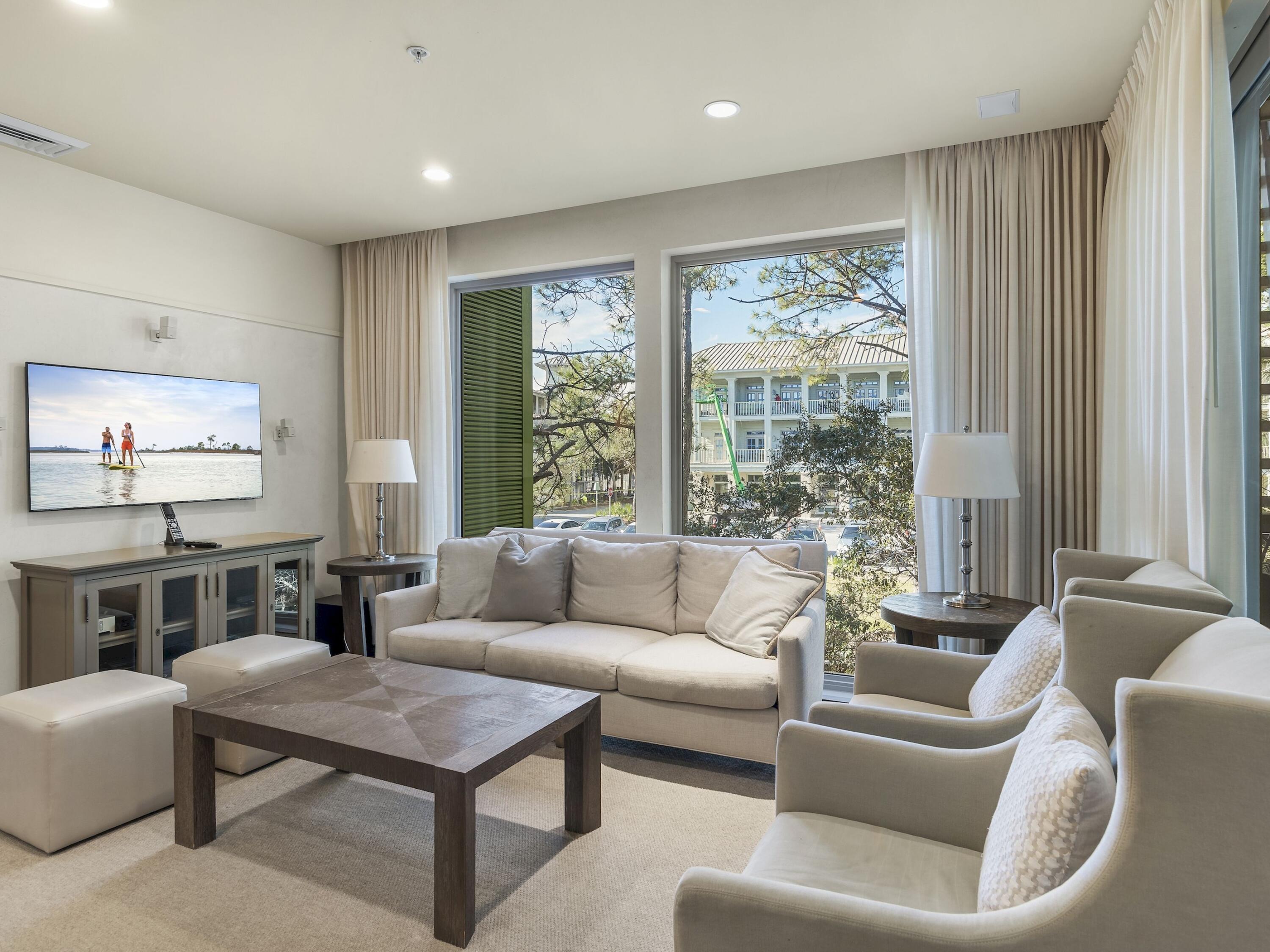 Poised within the highly sought-after WaterColor community along Scenic Highway 30A, this impeccably appointed two-bedroom, two-bath fractional ownership residence offers a rare opportunity to experience one of the Florida Gulf Coast's most celebrated private coastal enclaves. Designed with understated elegance and coastal refinement, the residence captures serene views of a lush canopy of longleaf pines through expansive floor-to-ceiling windows that bathe the interiors in natural light. The living spaces are defined by a calm, sophisticated aesthetic--neutral linen furnishings, warm hardwood flooring, and refined millwork come together to create an atmosphere of effortless coastal luxury. Every detail has been thoughtfully curated to balance comfort with timeless design.

The chef's kitchen is appointed to a high residential standard, featuring rich wood cabinetry, a striking dark stone island with integrated open shelving, premium stainless steel appliances, and a glass-tile backsplash that subtly reflects the natural light. An adjacent dining area with woven seating flows seamlessly from the kitchen, offering an inviting setting for intimate gatherings.

The primary suite and guest accommodations continue the same elevated design language, featuring hotel-inspired bedding, soft upholstered headboards, and spa-like baths with stone countertops, polished chrome fixtures, and classic tile surrounds. Natural textures and bespoke finishes throughout reinforce the home's serene, coastal character.