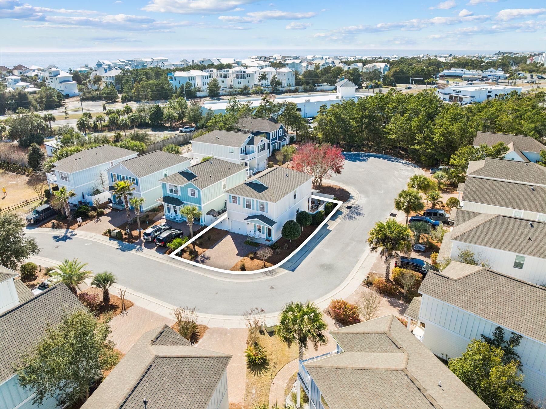 Life near the beach takes on a relaxed rhythm in this well-kept coastal home positioned on a desirable corner lot. Just minutes from the shoreline, the property offers convenient access to the beach pedestrian underpass, along with nearby restaurants and the scenic stretch of 30A easily reached by foot or bike. Designed for flexibility and comfort, the home works equally well as a primary residence, second home, or investment property in one of the most sought-after areas along the Emerald Coast. Inside, warm hardwood flooring runs throughout the first-floor living areas and continues up the staircase to the second level, adding a timeless coastal character. The open-concept layout connects the kitchen, dining area, and living room, allowing the spaces to flow naturally for both everyday  living and entertaining. The kitchen features granite countertops, wood cabinetry, and a functional layout that keeps the heart of the home connected to the surrounding gathering spaces. A convenient half bath and additional storage closets are also located on the main level, along with direct access to the single-car garage. Just off the living area, a covered patio provides a private outdoor setting for relaxing or hosting friends after a day at the beach. The fenced backyard is designed for easy maintenance with no grass to manage and includes a gate that allows guests to enter directly into the outdoor space without passing through the home. An additional storage area behind the fence along the garage side offers a practical place to keep kayaks, paddleboards, or other beach gear ready for the next adventure. All bedrooms are located on the second floor, creating a quiet and comfortable retreat from the main living areas. The primary suite features plush carpeting, a walk-in closet, and a spacious bathroom with double vanities, a soaking tub, and a separate shower. Two additional bedrooms share a Jack-and-Jill bathroom, offering both privacy and convenience for family members or guests. Positioned near the public beach pedestrian underpass and surrounded by some of the area's most sought-after coastal destinations, this well-maintained residence offers a flexible opportunity for those seeking a beachside home with strong rental potential and everyday livability along the Emerald Coast.