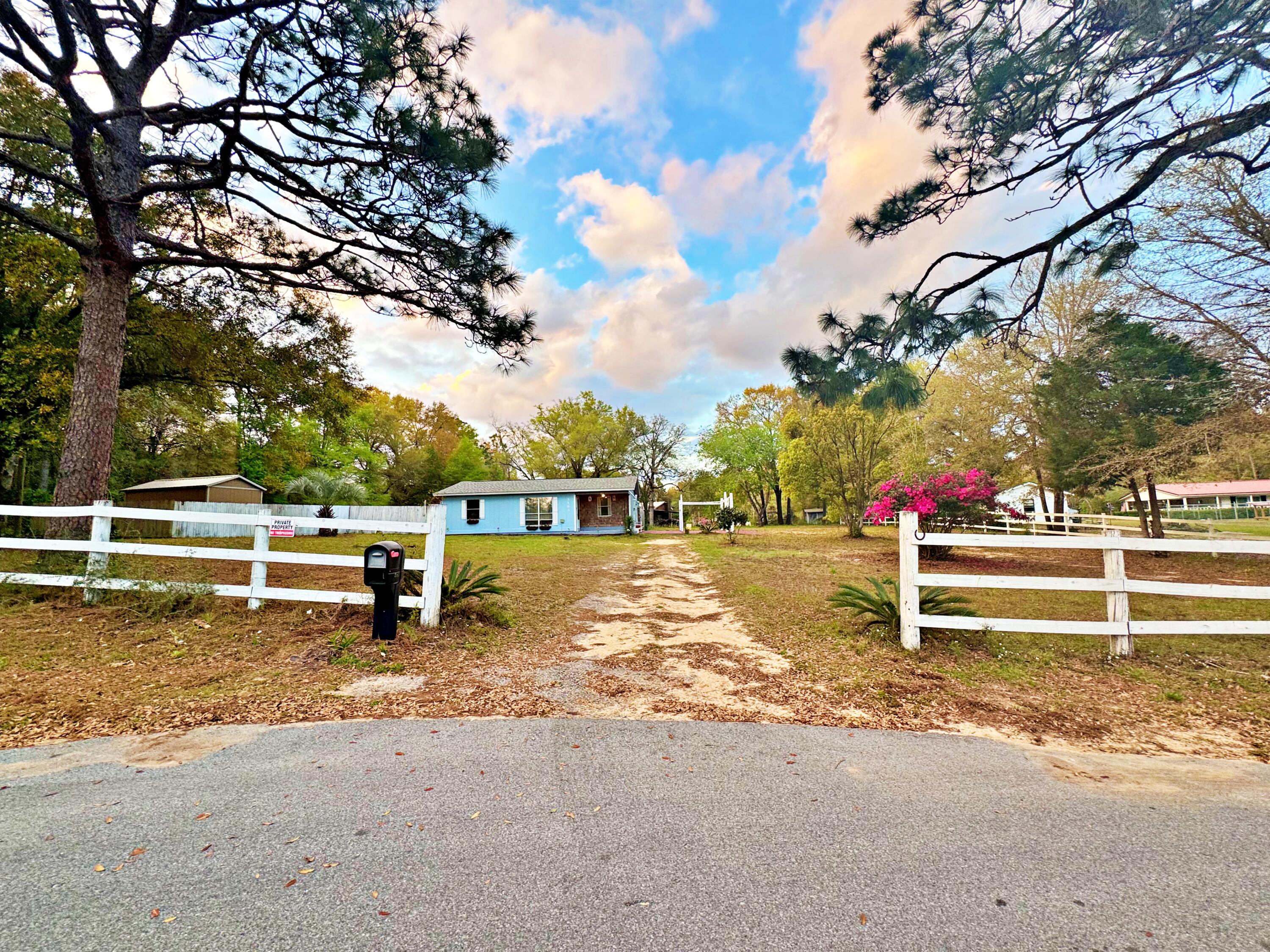 Welcome to this inviting 2-bedroom, 1-bath ranch on a private 1.00-acre lot in North Crestview. Features include a covered front patio, fenced in dog run, spacious living area, open dining/kitchen layout, and two well-sized bedrooms. Gracious storage shed directly behind the home. Roof and water heater was updated in 2020, flooring throughout was updated in 2023, and new HVAC installed Oct 2024. Move in ready!