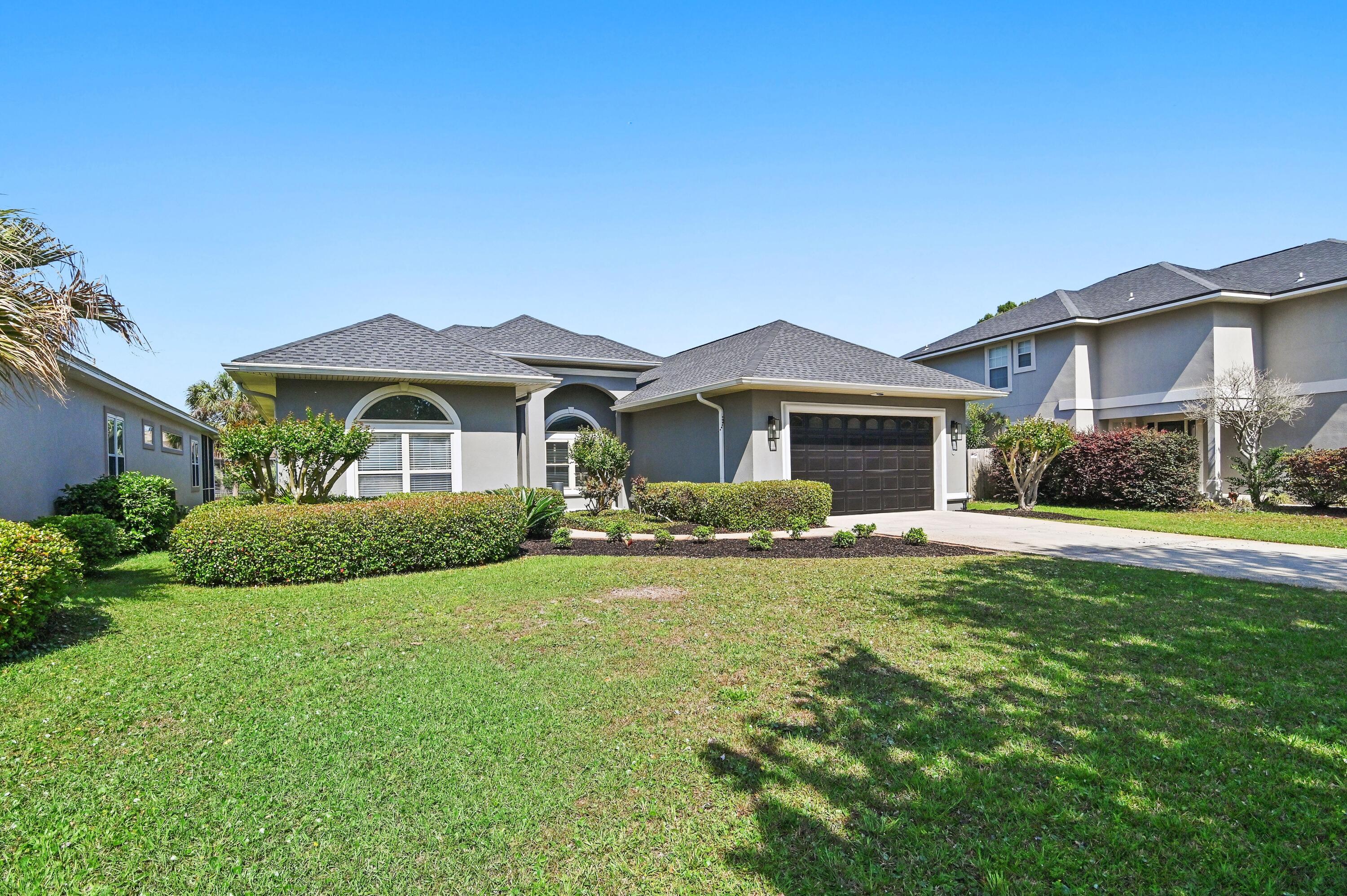 Newly updated home in the gated community of Emerald Lakes. Open floor plan with double doors leading out to the screened pool and patio from the living room, master bedroom and guest room. A large double heads, double bench shower has just been completed in the master bath. Other additions in 2025 were all new pool equipment, painted inside, new carpet, new microwave, professionally coated garage floor and updated landscaping. New roof in 2022. Enjoy the convenience of being 10 minutes to the beach and very close to shopping and dining. The neighborhopd community has tennis courts, basket ball, playground, barbque area and a community pool. The location of this charming home is on a cul de sac and features a large maple tree in the front yard. This home is a must see.