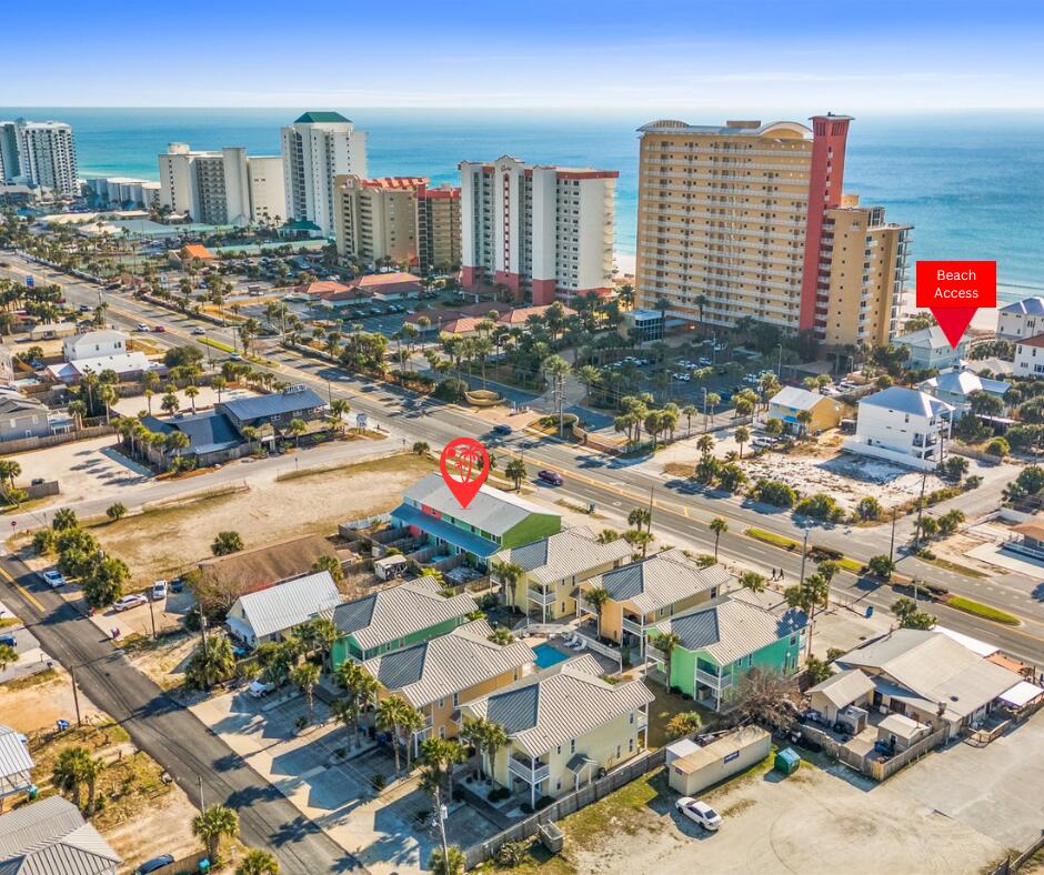 IT'S ALL ABOUT THE BEACH!  Just 900 feet to Beach Access 12A! This charming beach-style townhome is ideally located south of Grand Lagoon and has never been a vacation rental--only occasionally used by the owner. With no HOA restrictions, the possibilities are endless - whether you're looking to use it as your primary residence, a long-term rental, or as a profitable Airbnb investment.  Explore this delightful 2-story unit with an open-concept first floor, two bedrooms upstairs, and a spacious balcony.  The home is offered partially furnished and with a few of your touches it can be ready as your beach cottage or vacation rental.  Tile and LVP flooring make for easy cleanup of beach sand and metal roof keeps upstairs cooler.