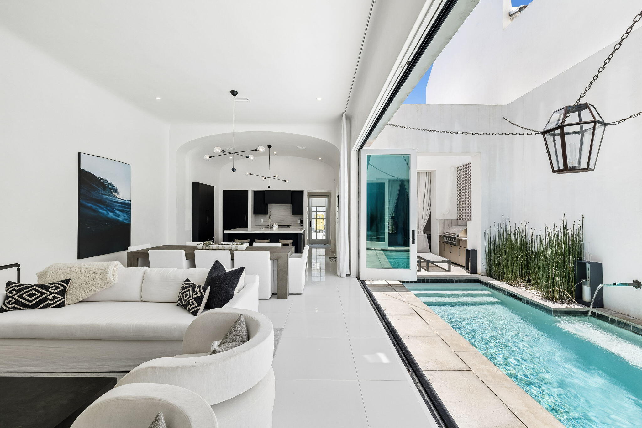 Experience the pinnacle of coastal luxury in the heart of Alys Beach, one of 30A's most  sought-after communities. Perfectly positioned south of 30A, this sleek and modern abode seamlessly blends sophisticated architecture with effortless indoor-outdoor living. A warm sense of welcome and effortless invitation greets you the moment you step through the front door, which fronts the iconic Turtle Bale pedestrian park.
Designed for both entertaining and relaxation, the home offers four spacious bedrooms, four full bathrooms, and two half baths, thoughtfully arranged across 3,031 sqft to provide comfort and privacy for family and guests alike. The main level living and dining areas feature expansive bi-fold doors creating a seamless transition between the elegant interiors and private outdoor courtyard, complete with a sparkling private pool, and covered logia perfect for lounging or outdoor entertaining. The chef's kitchen is equipped with everything you need including a Wolf gas range, ice maker, beverage refrigerator, and paneled appliances that blend in with the home's clean lines, curated finishes, and contemporary design. Enjoy sunset gatherings and coastal breezes from the stunning rooftop terrace, offering the perfect setting for entertaining or unwinding after a day at the beach. Within close proximity to the sugar-white sands of the Gulf and world-class amenities of Alys Beach, this exceptional residence presents a rare opportunity to own a modern retreat in one of the most exclusive destinations along Scenic Highway 30A.