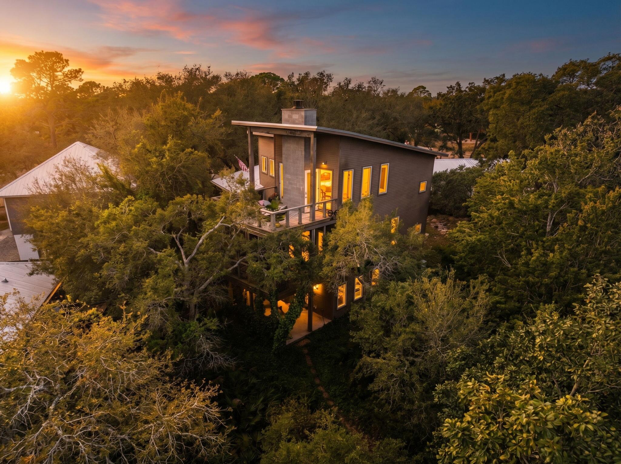 Welcome to ''Contentment,'' an architectural statement home on the shores of Lake Powell at 826 N Walton Lakeshore Drive. Custom-designed over several years by architect Frank Greene, former Town Architect for Rosemary Beach, and completed in 2018, this three-story residence was conceived to maximize light, air, and space while blending coastal lake living with a refined industrial aesthetic. The home takes its name from the entry sculpture created by a local Inlet Beach artist.

Inside, an open-concept floor plan unfolds beneath soaring ceilings accented by exposed wood and metal trim and painted floors with a well-worn patina that evokes urban-warehouse warmth. A custom three-story open stairway - handcrafted from the same structural beams that support the house - serves as a sculptural centerpiece, and four oversized pendants retrofitted from industrial highway mast lights anchor the main living space. A wood-burning fireplace with natural gas starter adds ambiance on cooler evenings.

The chef's kitchen is purpose-built for cooking: custom cabinetry with furniture-style bases, natural quartzite countertops, a raised island for ergonomic prep, dedicated knife and spice drawers, and a separate pantry/laundry room. Appliances include a new refrigerator/freezer, gas cooktop with downdraft vent, built-in oven, microwave, and a lower-level refrigerator/freezer.

The entire upper level is devoted to a private primary suite, opening to its own deck overlooking the lake. Each bath features an art-tile installation that nods to celebrated graphic and wildlife artist Charley Harper, paired with signature glass-block showers. A lower-level safe room/storage area, plus generous attic and crawl space, provide exceptional storage throughout.

While currently designed as a one bedroom primary residence, the property is positioned to be re-imagined into a 3 bedroom family home with minimal adjustments as depicted in images created. 

Outdoor living flows across three levels: a ground-level patio leading down a path to the private dock, a main-level screened porch, and the primary-suite deck above. The newly resurfaced dock offers social space and an outdoor hot/cold shower, a 5,000-lb. boat lift with a custom heavy-duty aluminum-framed canvas canopy, and a Seahorse-brand elevated double-kayak lift.

Additional appointments include impact-rated windows and doors throughout, a natural gas whole-house generator, a large Browning safe, and low-maintenance landscaping with native plants, ground cover, and natural rock. The covered front porch is accented by custom Rookwood tile wall art.

A rare opportunity to own a true custom, architect-designed lakefront home with direct water access on Lake Powell.