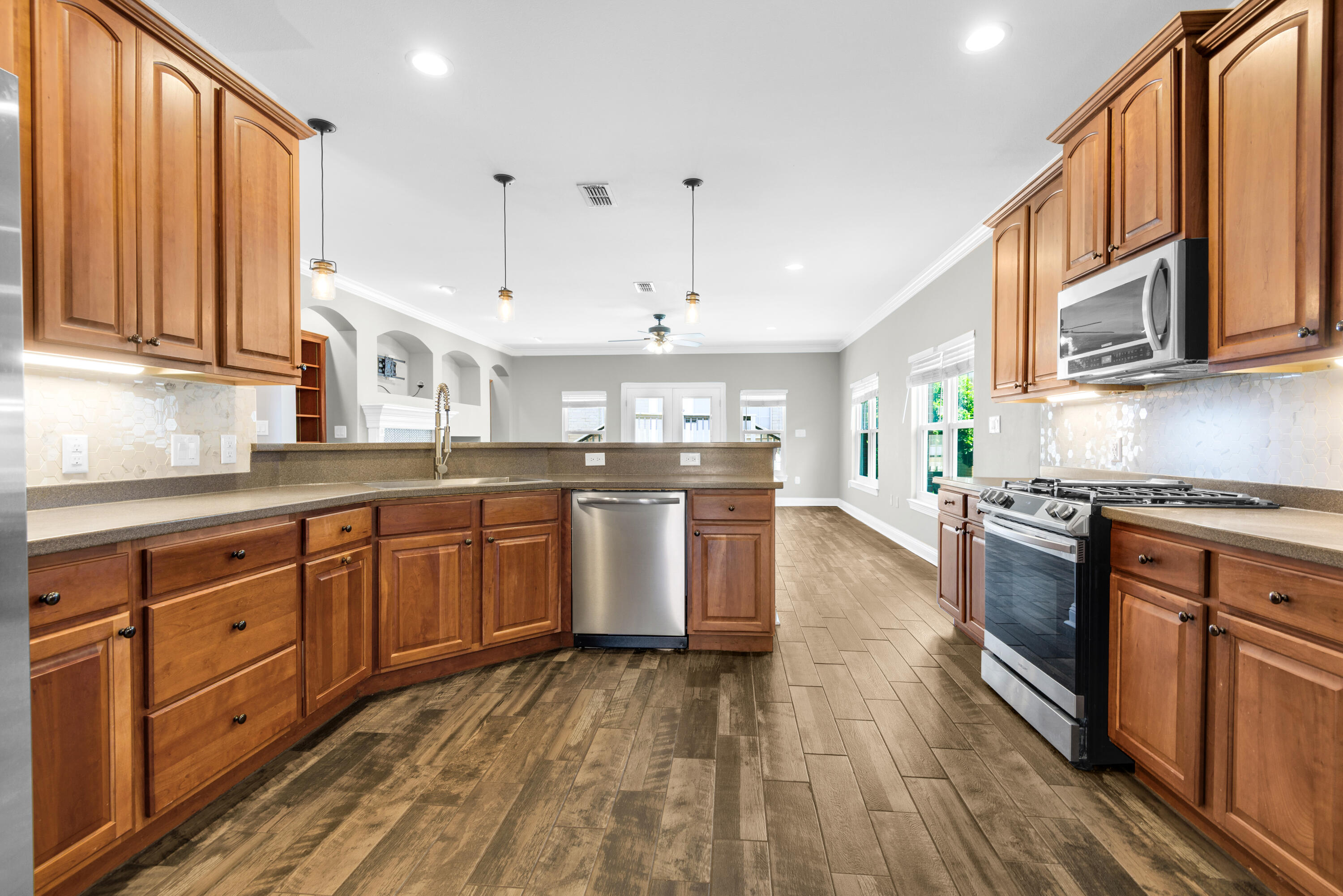 This beautifully maintained 3-bedroom, 2-bath home combines timeless charm with thoughtful modern updates. A welcoming foyer with soaring ceilings creates an impressive first impression, while elegant tray ceilings add architectural character to the dining area.The spacious kitchen is designed for both everyday living and entertaining, featuring tall cabinetry, under-cabinet lighting, Corian countertops, a newer refrigerator (2021), dishwasher (2026), and disposal. The kitchen opens seamlessly to the inviting family room, showcasing vaulted ceilings, recessed lighting, wood-look tile flooring, a custom-tiled gas fireplace, built-in shelving, and a wet bar with wine cooler.The private primary suite offers a relaxing retreat with a spacious walk-in closet and an ensuite bath featuring dual vanities, a garden tub, and separate shower. Two additional bedrooms provide generous closet space and share a well-appointed guest bath.Major system upgrades provide peace of mind, including a roof (2020), energy-efficient windows (2025), HVAC system (2018), tankless water heater (2018), garage door and motor (2024), well pump (2024), refrigerator (2021), and dishwasher (2026). This move-in ready home offers the perfect blend of comfort, style, and updated functionality.