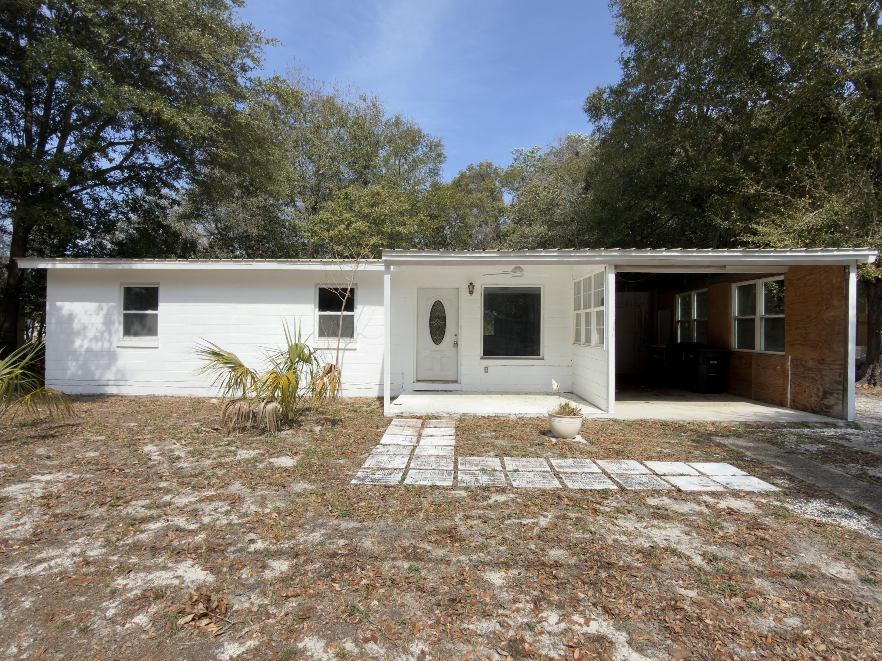 Located in the heart of Fort Walton Beach, this REO home may be your next opportunity. Built in 1956, this home has an attached carport, partially fenced back yard and deck at the back door. Laundry area is attached to the covered carport. This home has cinder block exterior and most of the windows have been updated to vinyl double pane windows; the metal roof finishes off the exterior. Inside, a typical 3 bed 1 bath floorp plan with living area, dining space and galley type kitchen. A must see if looking for FWB and options. Call today!