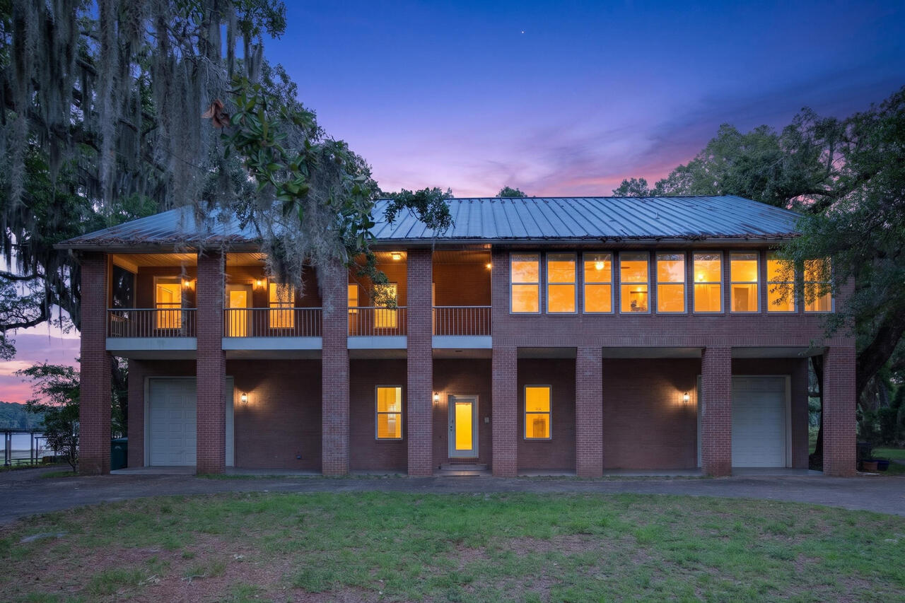 Some properties are built. Others are discovered. Hidden beneath the sweeping canopy of century-old live oaks where sunlight filters through draping branches and water views peek through the trees, this extraordinary 1.34-acre waterfront estate offers an experience that feels increasingly impossible to find along the Emerald Coast.
Spanning nearly 6,000 square feet across three levels, this impressive brick residence combines scale, flexibility, and waterfront living in a way few properties can. Offering five bedrooms, four-and-a-half bathrooms, elevator access to all levels, hardwood flooring throughout, and private en-suites for every bedroom, this home was designed for buyers who need more than space--they need options.
The thoughtful floor plan creates exceptional opportunities for multigenerational living, large households, guest accommodations, or those seeking a property capable of adapting alongside changing needs. Whether housing multiple generations under one roof or creating separate spaces for long-term guests, the layout provides both connection and privacy.
At the center of the home, the gourmet kitchen opens into expansive gathering spaces designed for entertaining on every scale. Multiple screened porches create natural extensions of the living spaces, offering peaceful mornings beneath the oaks, sunset dinners overlooking the water, and spaces large enough to host celebrations, holidays, and unforgettable gatherings.
The second level creates one of the home's most remarkable living spaces with walls of windows stretching across the home, flooding interiors with natural light while showcasing stunning basin bayou views that shift beautifully throughout the day.
Storage, recreation, and flexibility were clearly part of the vision behind this property. The third floor is finished and a blank cavas that could be used for 2000 sqft of storage or creative options that fit your vision. Two oversized drive-through bay garages create extraordinary opportunities for RV storage, boats, workshops, recreational vehicles, watercraft, or collections that require more than traditional garage space can offer.
Outside, the possibilities expand even further.
Launch a kayak or paddleboard directly from your property and explore the waterways leading toward the bay. Spend the day fishing in the lake or head toward the bay by way of the low bridge near the locals' favorite, Nick's Seafood Restaurant. Bring the boat, the RV, the jet skis, and all the water toys because this property offers one luxury that has become increasingly rare--freedom.
No HOA. No restrictive covenants. 
Located along Highway 20 with convenient access to Destin, marinas, dining, shopping, and the white sand beaches of the Emerald Coast, this property offers the rare combination of waterfront privacy while remaining connected to everything that makes coastal living desirable.
Luxury homes exist, Waterfront homes exist, Large homes exist. However, properties that combine all three with acreage, unrestricted use, multigenerational functionality, income potential, and a setting this remarkable are extraordinarily uncommon. There is simply not another property like this. Waterfront living without compromise. Unlimited potential with room to create whatever comes next. Call for your private tour today.