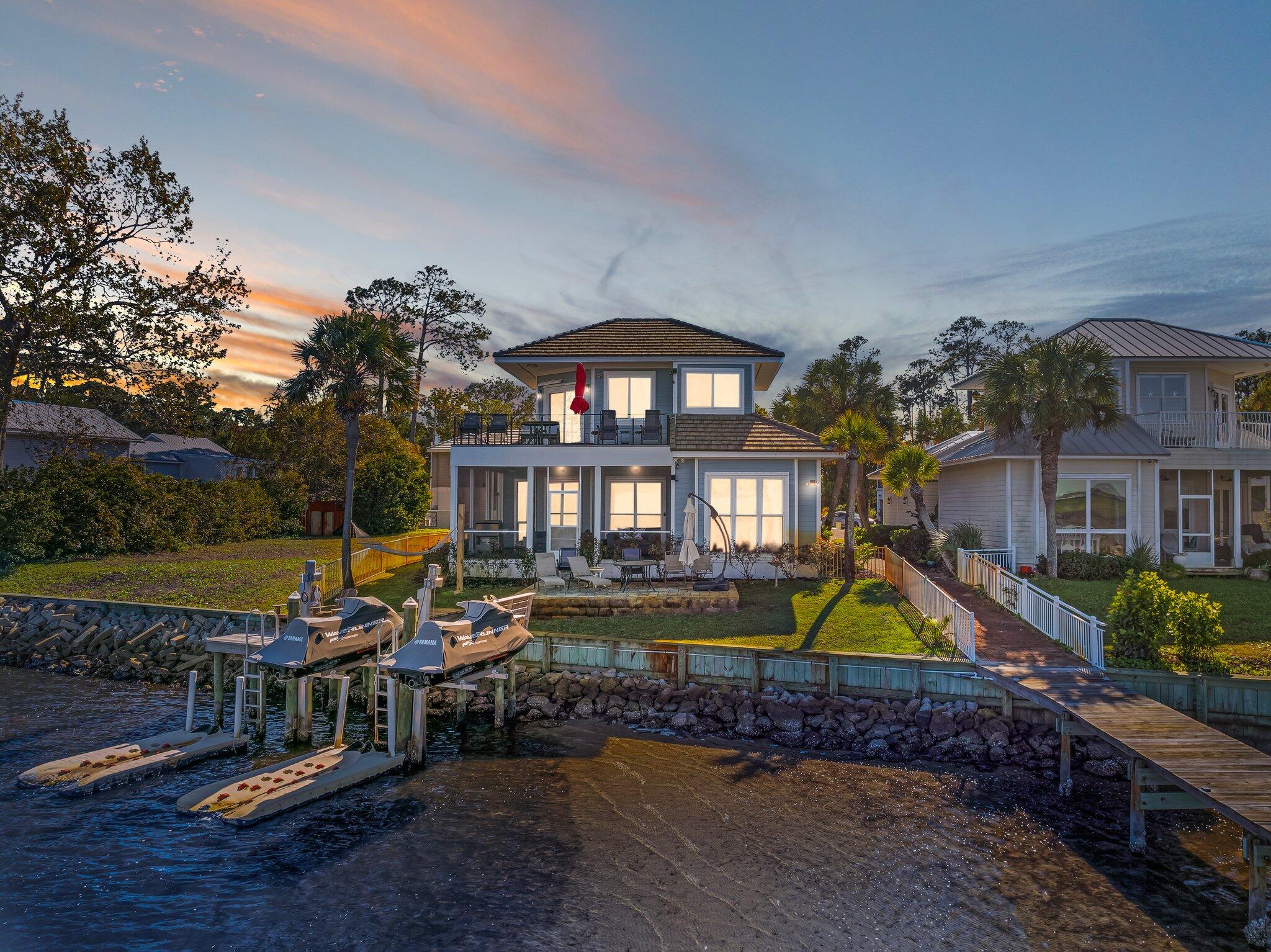 Discover your dream home with stunning waterfront vistas! Situated in the sought-after Bayshores Gardens community on the bayside of Miramar Beach, this open-concept residence invites you in with magnificent views and an abundance of natural light. This beautifully updated property boasts 3 bedrooms and 3 bathrooms, all within 2 miles of beach access, shopping, and a diverse array of dining options. The contemporary kitchen is a culinary enthusiast's paradise, featuring ample counter space ideal for entertaining friends and family. Expansive windows showcase breathtaking water views, allowing you to enjoy the scenery while dining at the breakfast bar or in the elegant dining area. Step outside to the newly constructed decking of the screened-in porch and unwind.