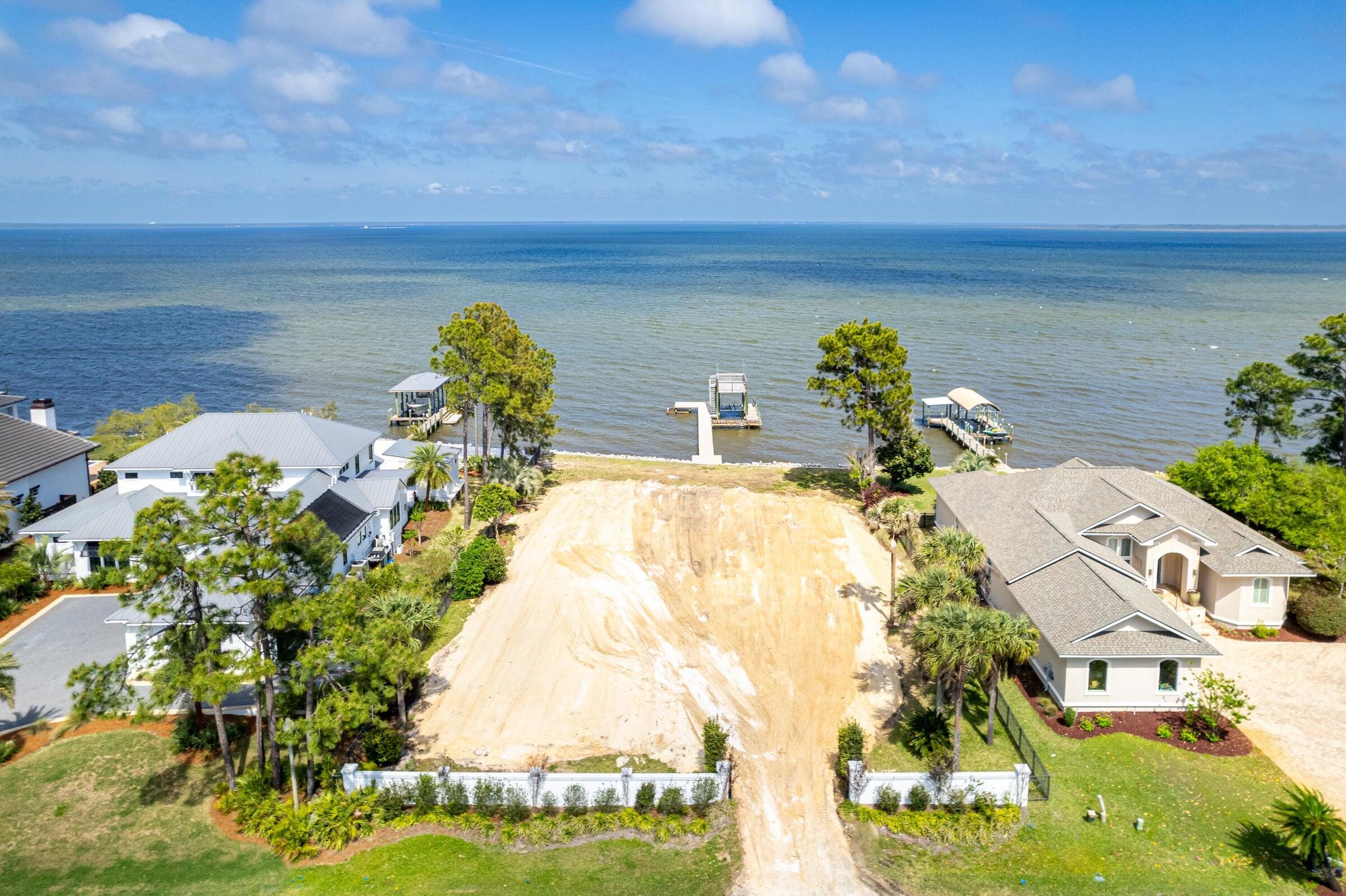 Rare and exceptional opportunity to build a spacious retreat perched on the banks of stunning Choctawhatchee Bay. Custom plans available, seawall, and dock in place. Lot graded and ready to build! Take a Sunday Drive down Driftwood Pt. Road where all eyes lead to the water. Escape to a private Oasis with 100' of bay frontage ad endless sunrises. Minutes from the Emerald Coast's finest beaches, shopping, dining and entertainment yet world's away from everyday distractions. Boating is easily accessible with the covered decking with deck featuring flow through docking. Lot improvements include seawall, front entry fencing, and dock.  Low HOA costs, friendly neighbors, and pink hued sunsets. Discover life on the bay!