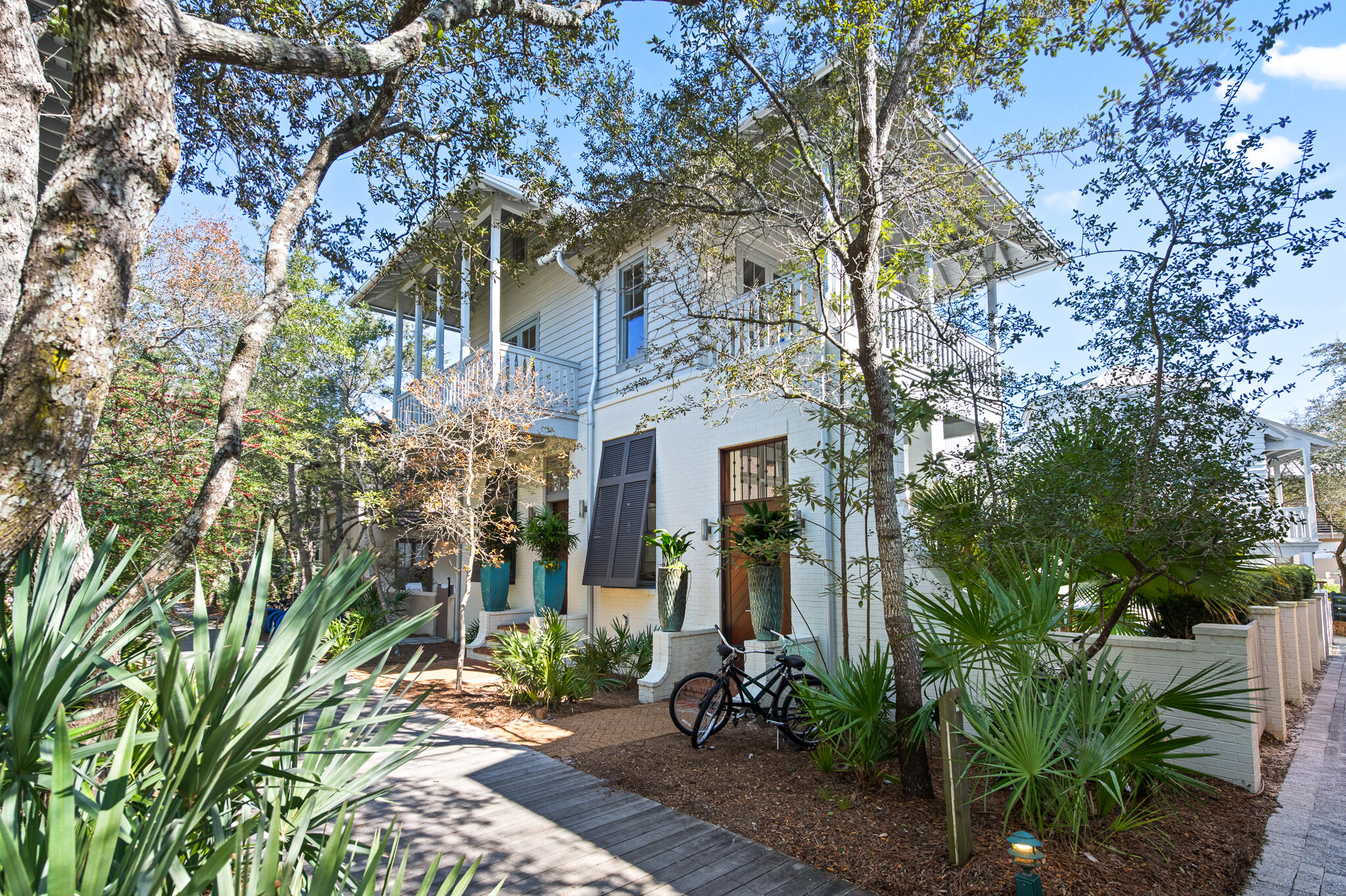 This impeccably maintained 5-bedroom, 7-bathroom home offers approximately 3733 square feet of thoughtfully designed interior living space, complemented by over 650 square feet of covered outdoor balconies and porches. The property includes a charming detached carriage house, ideal for guests or potential rental income.

The first floor showcases an expansive open floor plan that effortlessly blends sophistication with functionality. Dual living areas flow into a formal dining space, all anchored by a gourmet chef's kitchen featuring a professional Dacor range, Sub-Zero refrigerator, wine cooler, separate ice maker, and granite countertops. The butler's pantry with additional full-size refrigerator provides exceptional convenience for entertaining. Ascend to the second floor where three generously appointed master suites await, each offering private ensuite bathrooms. The stunning primary suite features a spa-inspired bathroom with double vanity and oversized walk-in shower, plus an expansive walk-in closet and exclusive access to two private balconies overlooking the lush courtyard and sparkling pool below. Conveniently located laundry facilities round out this floor.

The third floor reveals a versatile bonus retreat with four custom built-in bunk beds, full bathroom with walk-in shower, wet bar, and separate living area offering flexible space for relaxation and entertainment.

Step outside to your private oasis where the inviting pool and spa create the ultimate backdrop for coastal living. The outdoor living space is complete with built-in natural gas grill, multiple seating and dining areas, and an outdoor shower for rinsing off after beach days.

The detached carriage house epitomizes low-country charm with its open living concept and half bath on the main level. Upstairs, discover a serene bedroom suite with full bathroom. This self-contained retreat includes a full gourmet kitchen with stainless appliances, in-unit washer/dryer, and dedicated garage. Wrap-around balconies extend the living space and capture gentle coastal breezes.

Experience the coveted Rosemary Beach lifestyle in this exceptional property where every detail has been considered.