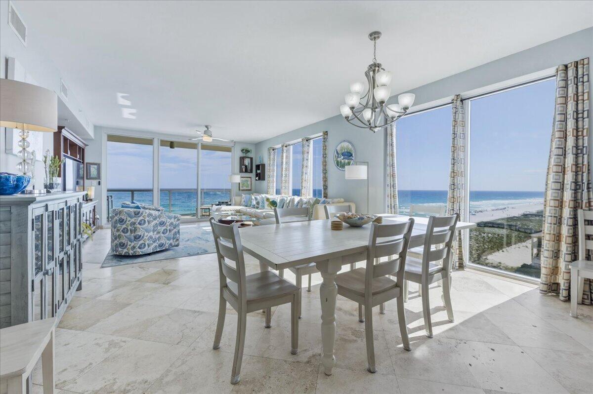 Experience the best of Navarre Beach in this high-producing, fully furnished West End corner unit at Caribbean Resort, where unobstructed Gulf and Santa Rosa Sound views take center stage! With over $95K in rental income generated in 2025 and a strong 10+ year rental history filled with stellar reviews and repeat guests, this is an incredible investment opportunity. There are no high rises blocking the panoramic views, allowing endless sunsets and natural light to pour in. The lockout unit creates rental flexibility and income potential. Inside, the main living areas are finished with travertine tile and vinyl flooring in select bedrooms - no carpet! The living and dining area features floor-to-ceiling windows that frame the Gulf and Sound, creating a bright, airy coastal atmosphere. The kitchen showcases custom cabinetry, glass-pane lighted upper cabinets, abundant storage, stainless steel appliances, granite countertops, a built-in wine rack and stemware holder, and a breakfast bar. The primary suite easily accommodates a king-size bed and sitting area and features balcony access and a walk-in closet. The guest bedroom includes a walk-in closet and a convenient ensuite bathroom, with access also available from the main living area. The lockout suite can be accessed both internally and from an exterior entrance, making it ideal for maximizing rental income or hosting guests. It offers its own balcony, en suite bathroom, double closets, and space for a sitting area. Additiona l highlights include a hidden laundry area concealed behind kitchen cabinetry, generous storage throughout, and a dedicated owner's closet. Caribbean Resort offers fantastic amenities including a Gulf-front pool, hot tub, gated beach access, two parking spaces per unit, private storage, and a recently renovated BBQ area with new grills. This is a rare opportunity to own a proven income-producing beach property with unbeatable views!
