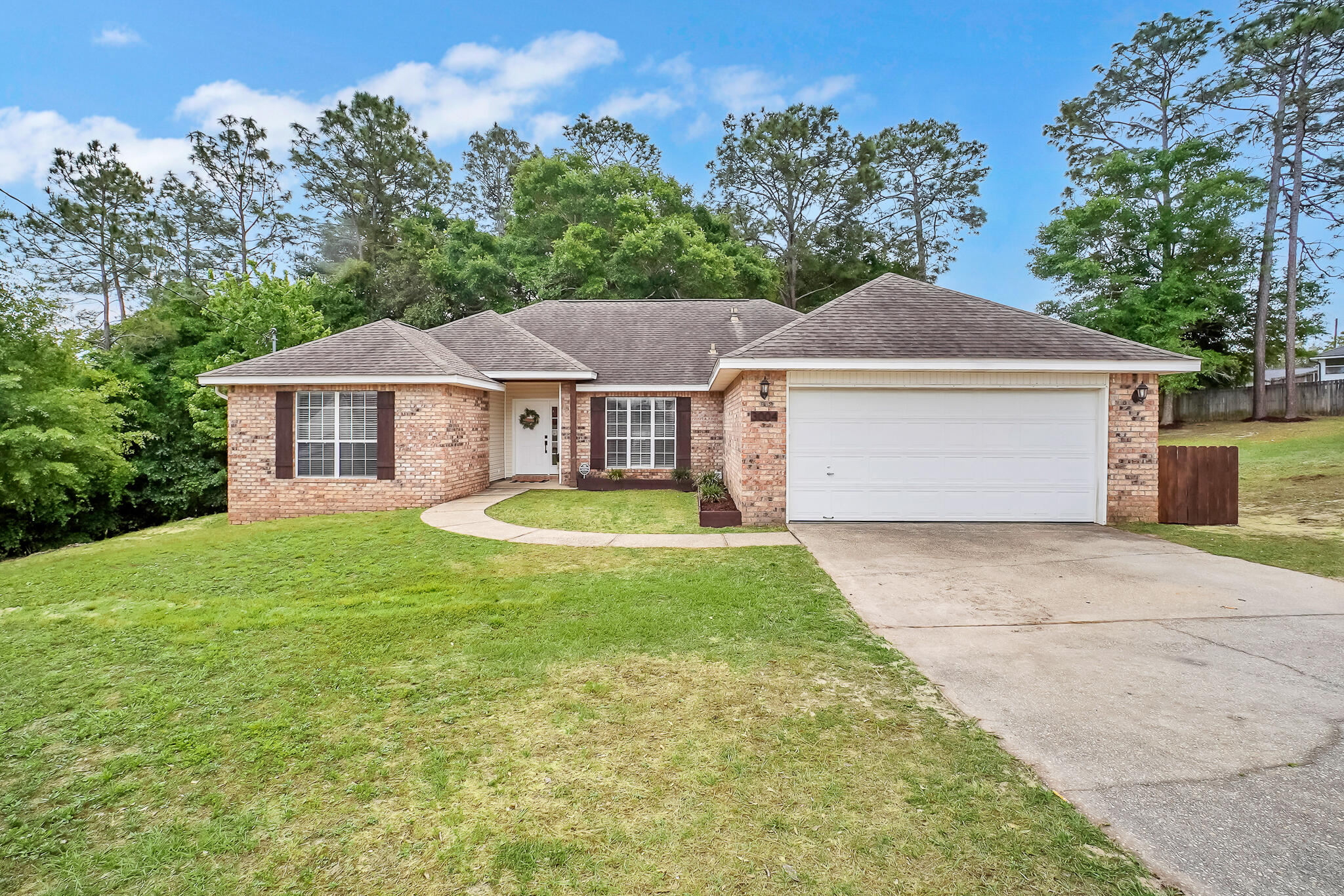 This spacious 4 bedroom, 2 bathroom brick home is situated on a 1.12 acre lot. Tucked away in a quiet cul-de-sac in a desirable South Crestview location, just off the first traffic light, it offers convenience and privacy. It is approximately 6 miles from 7th SFG/Duke Field, and 21 miles from Eglin AFB. Inside, you will find a functional split floor plan. The main living area features vaulted ceilings, LVP flooring, and updated fixtures. The kitchen is complete with granite countertops and stainless-steel appliances. The primary bathroom includes a walk-in closet, a linen closet, a separate garden tub, shower, and a private toilet room. Spend quiet evenings on the large back deck overlooking green space, offering added privacy and peace of mind with no future development behind you.