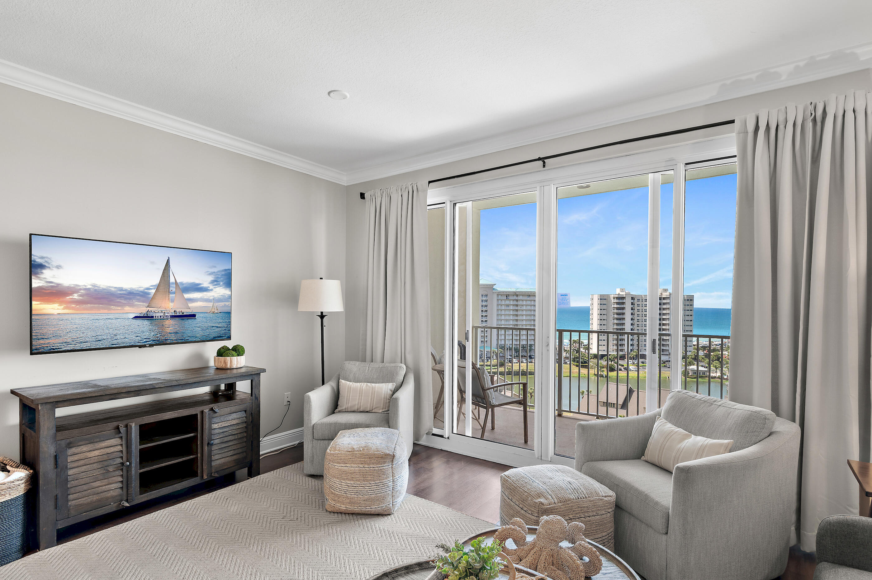 Perched on the 11th floor, this beautifully appointed luxury condo offers sweeping, unobstructed views of the Gulf of Mexico and is just a short stroll to the sugar-white sands. With 732 square feet of thoughtfully designed living space, this turnkey property is being sold fully furnished and is rental-ready--making it an ideal investment opportunity or coastal retreat. The inviting living area features a comfortable sofa sleeper, stylish coordinated décor, and a large flat-screen TV, creating the perfect space to relax after a day at the beach. The fully equipped kitchen boasts elegant cabinetry, stainless steel appliances, and granite countertops, along with a breakfast bar with seating for three--ideal for casual dining and entertaining. A convenient in-unit washer and dryer add to the ease of everyday living.

The primary bedroom offers a king-size bed, flat-screen TV, and direct access to a well-designed Jack-and-Jill style bathroom, which is also accessible from the hallway. A built-in bunk nook in the hallway provides two twin beds with cozy bedding--perfect for additional guests or family.

Located in the desirable Ariel Dunes II building within Seascape Resort, residents enjoy access to exceptional amenities including two resort-style pools and a fitness center. The larger resort community offers private beach access, on-site dining and drinks, tennis and pickleball courts, and the security of a gated entrance--delivering the ultimate coastal lifestyle experience.