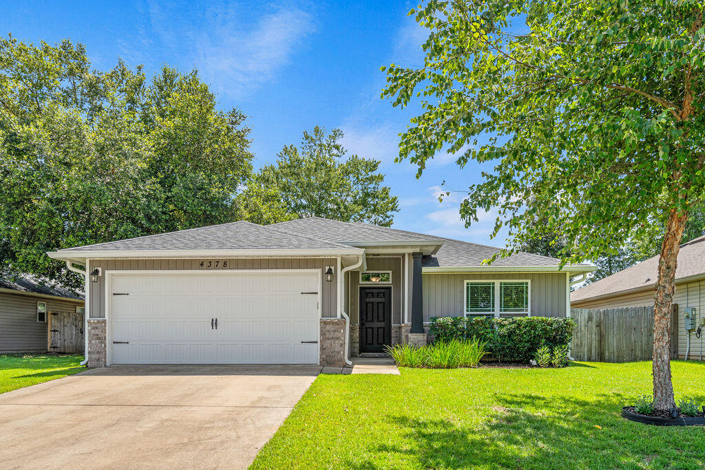 Welcome to this well-maintained, all-electric Henry Home in the highly desirable Pace School District. Thistle Pine Court sits on a cul-de-sac, and the neighborhood features underground utilities, streetlights, and sidewalks for a welcoming setting. A spacious foyer opens to the inviting great room with a vaulted ceiling, plant ledges, and ceiling fans. The open-concept kitchen overlooks the living area and offers a raised breakfast bar with pendant lighting, granite countertops, a double undermount sink, pantry, and stainless Whirlpool appliances, including a smooth-top range, built-in microwave, dishwasher, and garbage disposal. Luxury vinyl plank flooring extends through the main living areas, with carpet in all bedrooms. The breakfast area opens through double French doors to a covered back porch, ideal for relaxing or entertaining. The spacious master features tray ceiling, ceiling fan, and a luxurious en-suite bath with double granite vanities, a garden tub, separate shower, private water closet, linen closet, and oversized walk-in closet. Two additional bedrooms share a hall bath. The laundry room is conveniently located just off the kitchen with direct access to the attached two-car garage. Outside, enjoy a large fenced backyard with a storage shed and plenty of space for outdoor activities, gardening, or pets. Community amenities include a splash pad, playground, and expansive green spaces, all within a short walk or bike ride from the home. Don't miss this rare opportunity to own this well-maintained home! Located in Flood Zone X, this property does not require flood insurance by most lenders, offering added peace of mind and potential savings. Whether you're looking for a primary residence, vacation home or investment property, this home is one you won't want to miss.