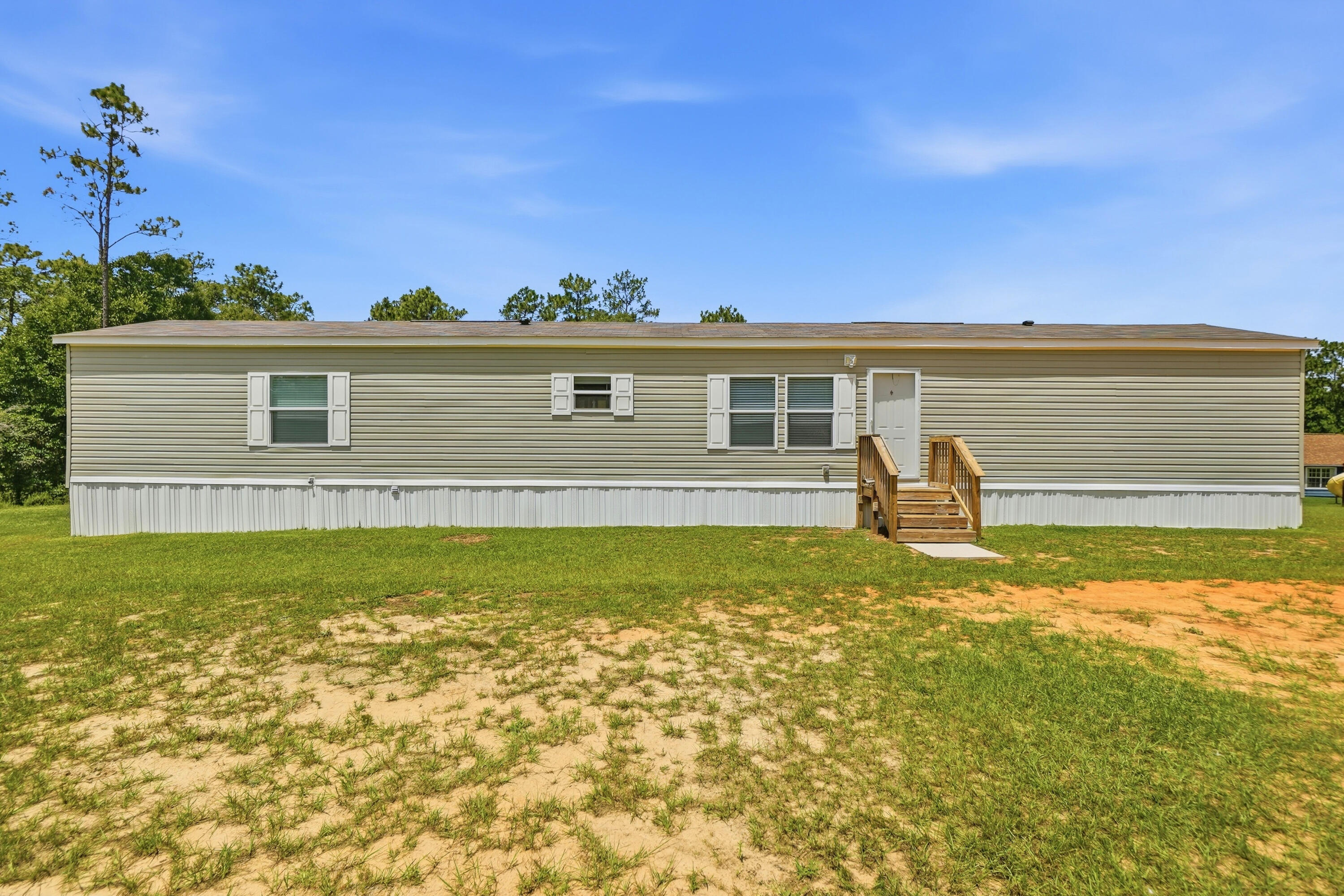 3BR/2BA Home on 2.34 Acres - Holt, FL
Built in 2023, this spotless, well-maintained 3-bedroom, 2-bathroom home sits on 2.34 acres in Holt. From the moment you walk in, the care put into this home is evident -- every space feels fresh and move-in ready.
The split-bedroom floor plan places the master suite apart from the secondary bedrooms, offering added privacy. Luxury vinyl plank flooring runs throughout, giving the home a clean, cohesive look while standing up well to daily wear.
The master bedroom is generously sized, with plenty of room for a full furniture set. The master bathroom features a soaking tub and separate shower, along with space to comfortably move between the two. The secondary bedrooms are well-proportioned and share access to the second full bathroom.
Outside, the 2.34-acre lot is roughly half cleared, offering open space for outdoor activities, gardening, or future expansion, while the remaining acreage is left in natural, wooded privacy. A pole barn on the property provides covered storage for equipment, vehicles, or tools, keeping them protected from the elements.
This property offers a combination of a well-kept home and usable acreage, suited to buyers looking for both comfort and space.