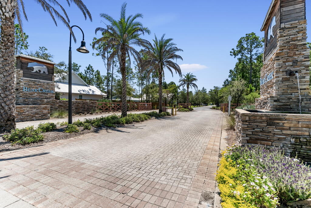 Located directly across from the tranquil neighborhood pond, Lot 53 Hibernate Way offers a rare opportunity to build your ideal home in one of the most desirable gated communities along the Emerald Coast. With peaceful water views and a thoughtfully positioned homesite, this lot provides the perfect canvas for a primary residence designed around both comfort and lifestyle.  Just over the 331 bridge, Bear Creek is known for its natural beauty, quiet setting, and strong sense of community--where full-time residents enjoy a more relaxed pace while remaining conveniently close to everything South Walton has to offer. The white sand beaches of 30A, dining, shopping, and everyday conveniences are all within easy reach. Life in Bear Creek is centered around connection and recreation, with amenities that include a resort-style pool, tennis and pickleball courts, basketball court, playground, fitness center, and scenic walking paths woven throughout the neighborhood. With short-term rentals prohibited, the community maintains a peaceful, residential atmosphere that's increasingly hard to find in this area.

Whether you're looking to build now or secure a homesite for the future, Lot 53 Hibernate Way represents an opportunity to create something truly special in a setting that blends nature, convenience, and community.