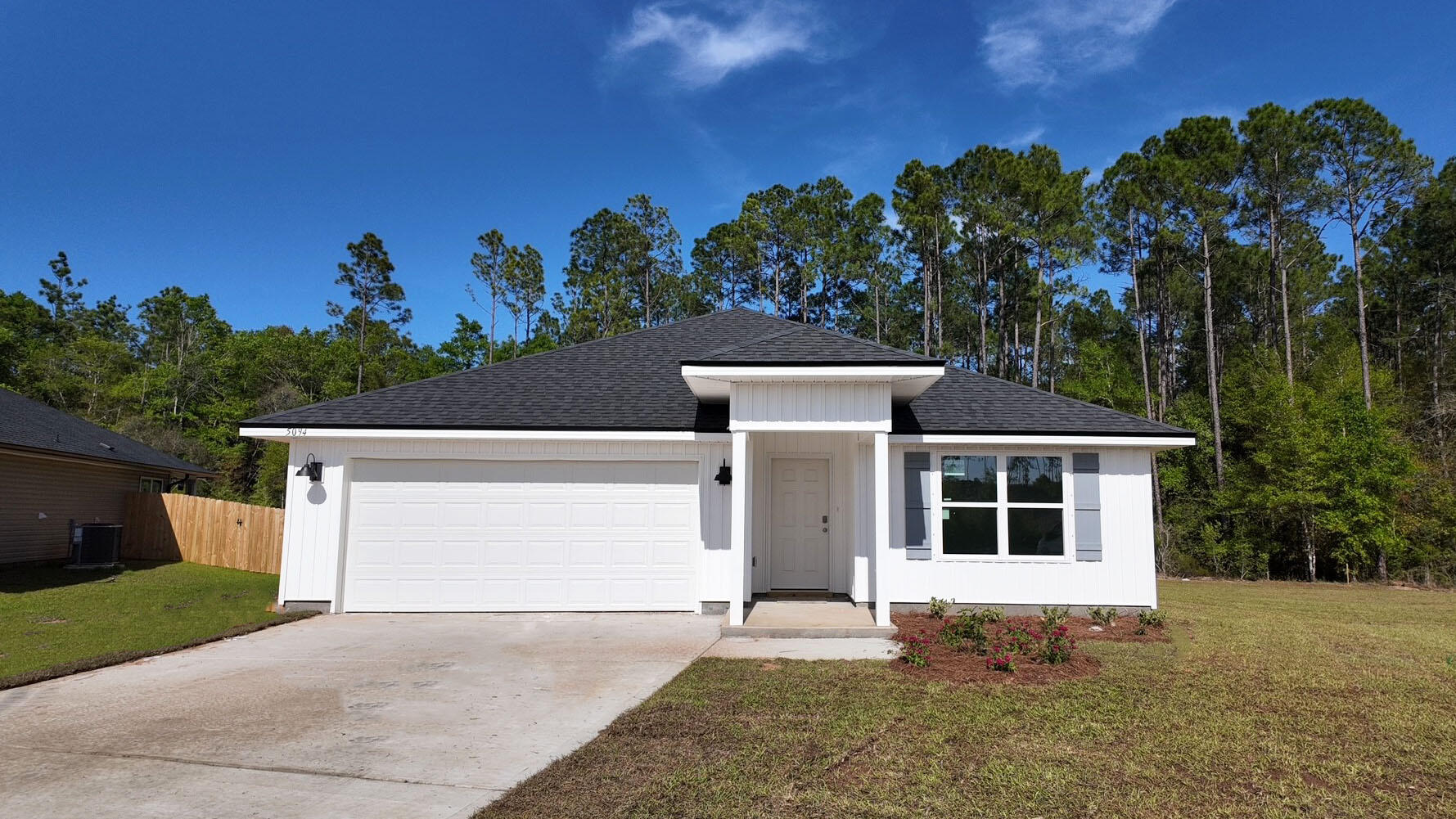 Welcome to Liberty Farms Community! The Cali model, one of our most sought-after designs, offers a fantastic open layout for relaxed living. Offers 4 bedrooms, 2 bathrooms, a covered back patio, 2-car garage, and the 'Smart Home Connect' System with various convenient Smart Home devices. The well-appointed kitchen includes stainless steel appliances, a smooth-top range, built-in microwave, quiet dishwasher, corner pantry, island bar, eye-catching wood-look flooring, and plush carpet in the bedrooms. Laminate Countertops in the Kitchen & Baths. Bedroom 1 and the adjoining beautiful bath boast a large walk-in closet, double vanity sinks, and more. Fabric Hurricane window and door protection is also included. Enjoy the stylish curb appeal with easy access to the interstate. ALL LISTING pictures, colors, features, and size may vary. Square footages are approximate.