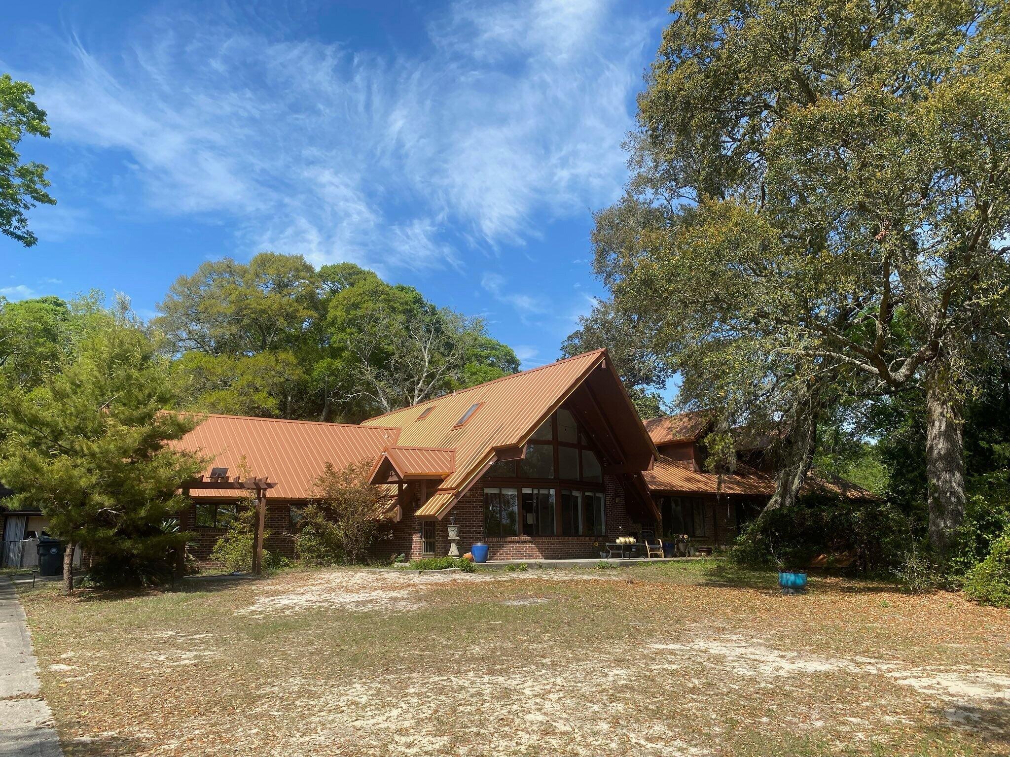 Need a big home so you can spread out, with 5+ bedrooms ( 3 of them are master bedrooms ), and 6.5 baths?  This home sits on just over an acre, and has upgrades to it, including a renovated kitchen w/ marble counters, a huge island / brkfst bar, and two electric ovens with a propane gas tank fed burners over one of the two ovens!  This home has a distinctive copper looking roof, and sits well off of Hwy 20.  The driveway is lined with azaleas, and the detached garage is at the back of the property.  The foundation is solid with the basement being concrete block and the home is on slab with brick siding!  You would not think you have that much room till you go in and see it!  You have 4,088 sq ft of heated and cooled space, and an additional 1,672 sq ft of unfinished, but... (Pls click on) heated and cooled room!  That amounts to about $100.99 / sq ft! Several of the bedrooms have new LVP flooring and one of the master bedrooms has had the flooring removed, so you can upgrade it with what you prefer.  The 3 master bedrooms are on the main floor, and there is a 4th bedroom on that level, too!  The 5th bedroom is a cathedral ceilinged one that is just off the stairway, past the bathroom!  But there are two huge rooms to the right (see photos) that could also be bedrooms (with a wall unit or chifforobe), or make one a game room, and  still room for a pool table, foosball, etc.  Come up with your own ideas of how you can utilize this phenomenal space!  Being sold as-is.  Call for your appointment, today!  Cheers!