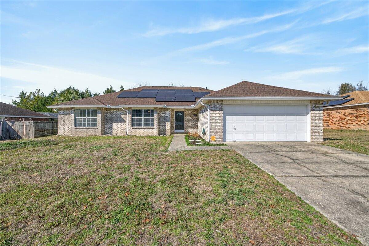 2.675% VA assumable loan, brand-new roof (Jan 2026), and solar panels for improved energy efficiency and lower electric costs. Located south of I-10 in Westview Estates, this all-brick single-story home offers 3 bedrooms, 2 full baths, plus a dedicated office/flex space. The open living area features cathedral ceilings and a fireplace, creating a welcoming focal point. The kitchen and dining area provide ample space for everyday living and entertaining. The primary suite includes double vanities, a garden tub, a separate shower, and two walk-in closets. Enjoy the fenced backyard with an open patio and a storage building. Conveniently located near schools, shopping, and Eglin AFB. Schedule your showing today!