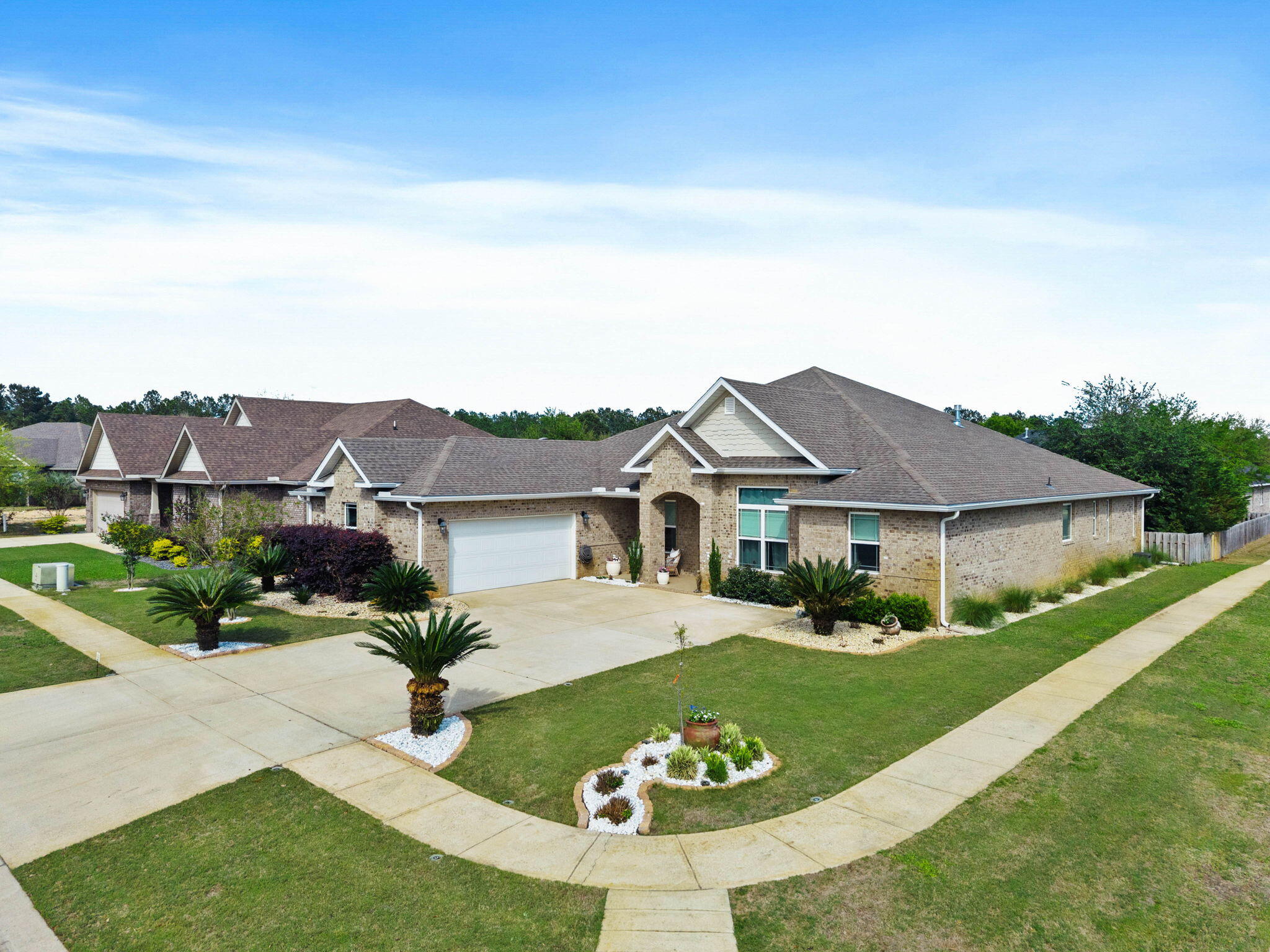 Experience refined living in Hammock Bay, where this custom masterpiece stands apart from the rest. The open living area shines with a coffered ceiling, gas fireplace, and built-ins. A chef's kitchen features a massive granite island, gas cooktop, double ovens, and a butler's pantry. The private primary suite offers a trey ceiling, soaking tub, and oversized closet, while guest bedrooms occupy a separate wing. Unique upgrades include arched doorways, crown molding, and a media room with removable risers. Complete with a large tiled laundry and matching granite throughout. Step outside to your private oasis: a screened Florida room and patio complete with a hot tub. this home offers more than luxury-it provides access to Hammock Bay's resort pools, fitness center, and trails. Tour Today!