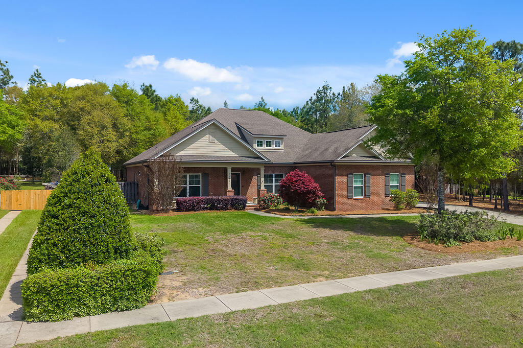 72 hour kick out clause in place. Are you searching for privacy, peace, and true country living? Look no further, this is the home you've been waiting for. Tucked away at the end of the subdivision, this stunning Randy Wise-built home offers the perfect blend of seclusion and style. From the moment you arrive, you're welcomed by a custom extra wide driveway and sidewalk that extends beyond the fence for a RV or boat, leading to a spacious side-entry garage. This Craftsman-style home showcases timeless design paired with modern comfort. The heart of the home features an open-concept living, dining, and kitchen area--ideal for both everyday living and entertaining. Throughout the 4-bedroom, 2-bath layout, you'll find elegant upgrades including crown molding throughout, 6-inch baseboards, and granite countertops. The kitchen is a true showstopper, complete with professional-grade stainless steel appliances, custom cabinetry, and a large island that overlooks the family room. The private primary suite offers a relaxing retreat with plush carpeting and a spa-inspired bathroom featuring an oversized walk-in shower with glass enclosure, garden style soaking tub and an expansive walk-in closet. Enjoy year-round outdoor living in the Florida room, built by Titan Sunrooms, featuring impact glass windows for comfort and durability, as well as a split AC/Heat unit. Step outside to a beautifully manicured, fully irrigated backyard oasis. The fully fenced yard also includes a 14x14 outbuilding constructed with brick and Hardie board, perfect for storage or hobbies. For buyers peace of mind and energy efficiency, spray foam is in the attic for extra insullation, and there is a termite bond with Bryan Pest Control. 
This exceptional property truly has it all, come and view today.