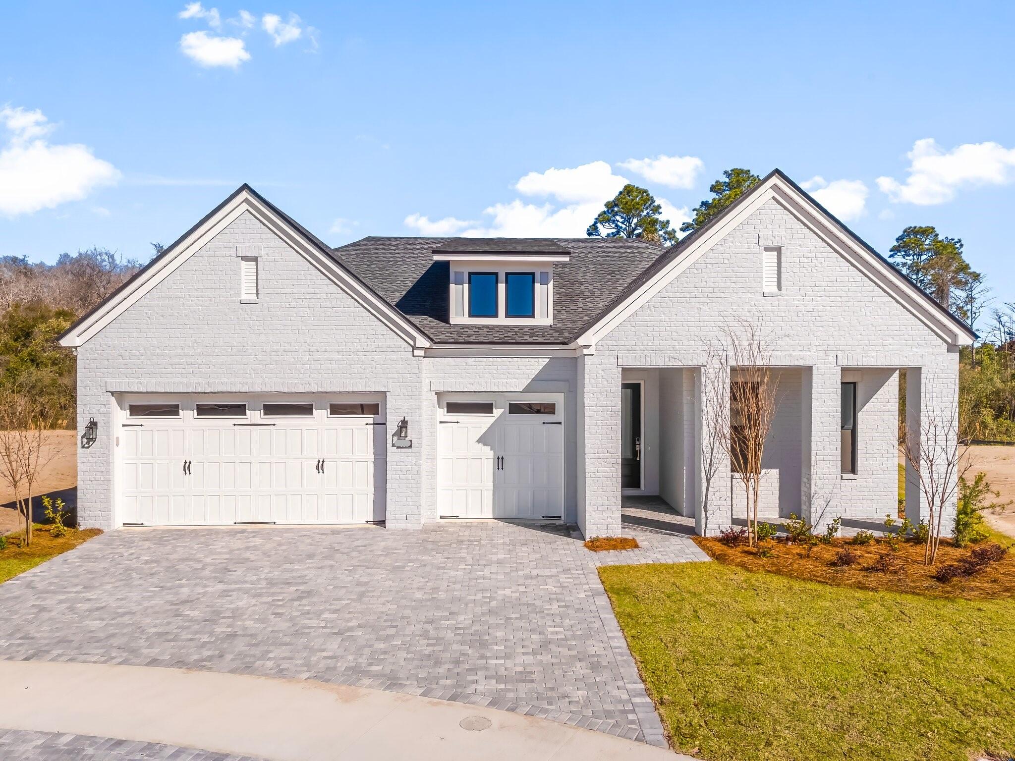 Stunning single-story 3 car garage Toll Brothers home. Construction completion estimated January 2027.  Limited time to make your personal selections at design studio. Offering 2,844 square feet of living space. Boasting 4 spacious bedrooms, office/flex room and 3.5 beautifully appointed bathrooms, this residence exudes elegance and comfort at every turn. The soaring 12-foot ceilings in the grand foyer set the tone for the home's grandeur, with 10-foot ceilings throughout the rest of the living areas, adding to the airy and open feel. The expansive open floor plan includes a office room, perfect for working from home, and a three-car garage with a stylish paver driveway. Step into the heart of the home, the gourmet open kitchen. Here, you'll find exquisite quartz countertops, large island, and stainless steel appliances, making it ideal for both cooking and entertaining. Bathrooms feature elegant tile finishes. The primary suite is a true retreat, with two walk-in closets offering ample storage space and bathroom designed to pamper with a spa-like atmosphere large soaking tub and walk-in tile shower. Enjoy outdoor living on the covered paver lanai, which overlooks a serene private wooded preserve, providing the ultimate in peace and privacy. The beautiful gated community enhances your lifestyle, offering easy access to a variety of amenities including a resort-style pool, clubhouse, fitness center, tennis and pickleball courts, playground, multi-purpose field, and much more Short drive to public beach access, Pier Park shopping, dining and fun entertainment, airport, future FSU/TMH medical campus, future West Bay Center with Publix, and recreation outdoor activities at Frank Brown Park. This home is more than just a place to live, it's a lifestyle waiting to be embraced. Call today to schedule your private tour! Pictures are stock photos and not of actual home.
