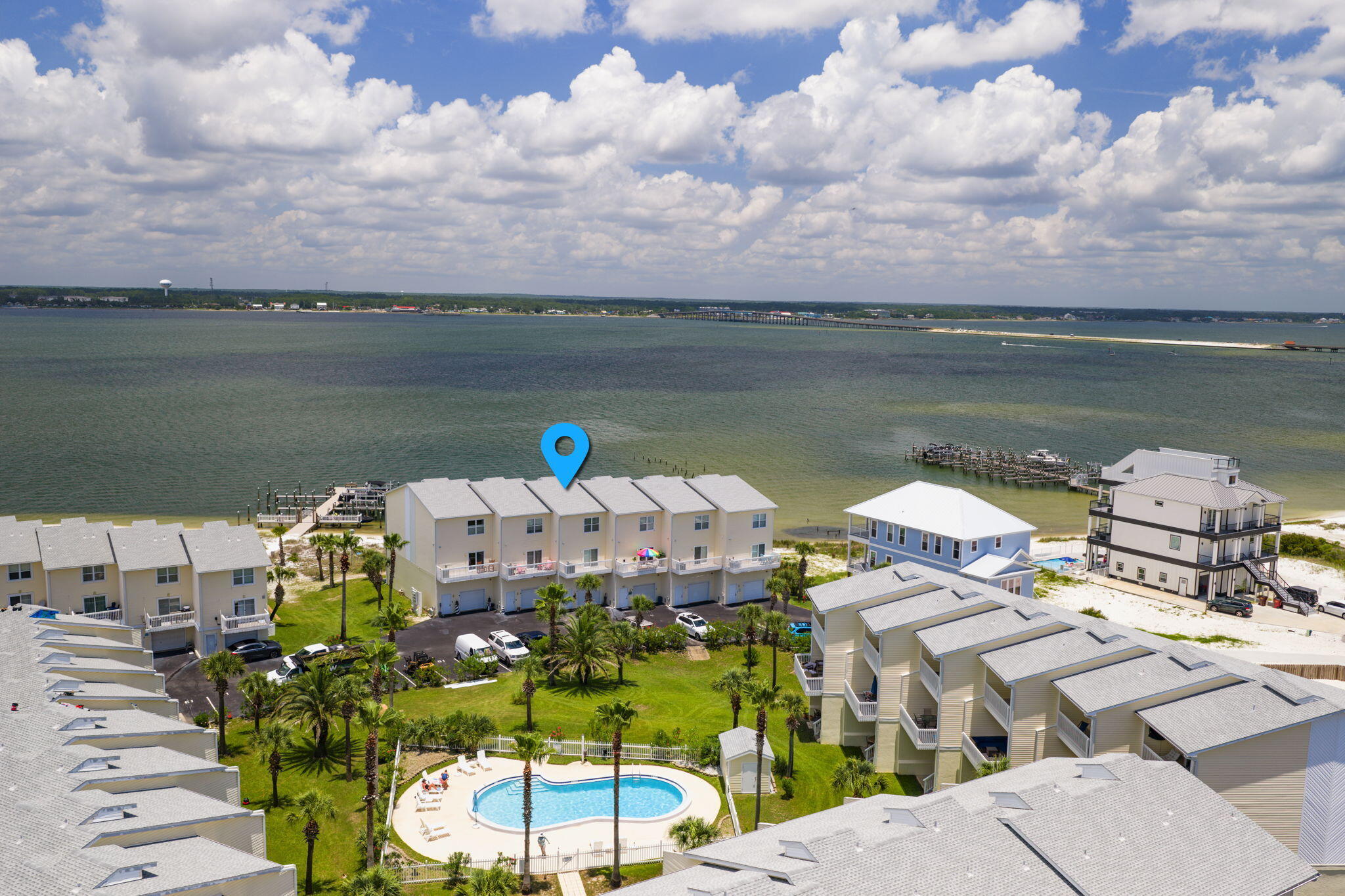 This must be living in PARADISE... welcome to PARADISE POINT on Navarre Beach!
Situated at one of the highest elevations on Navarre Beach, Paradise Point offers an incredible opportunity for those who love boating, water views, and coastal living. Located directly on the Intracoastal Waterway and only a half block from the Gulf Islands National Seashore, plus nearby restaurants and local favorites, this location truly delivers the best of beach life.
This spacious 3-story townhome features 3 bedrooms, 3.5 bathrooms, and your very own private deep-water boat slip--making days on the water effortless.
The ground level offers a blow-out design beneath the living area with easy access to the 1-car garage, ample storage for beach gear, and direct access to the backyard and Intracoastal.
The first living level includes a versatile guest bedroom that could also serve as an ideal home office.
On the main living floor, you'll find an open-concept layout designed to maximize water views. The kitchen features granite countertops, abundant cabinetry, a full laundry room, and additional storage space. The kitchen overlooks both the dining and living areas, all with beautiful views of the Intracoastal. Step outside through the sliding glass doors onto the expansive covered balcony--perfect for entertaining friends and family or simply relaxing while watching boats pass by. A convenient half bath completes this level. Upstairs are two generously sized ensuite bedrooms, including the primary suite, both offering excellent closet space and privacy. Primary bedroom has a waterview of the Intercoastal/Navarre Sound. 
Throughout the home, you'll appreciate the thoughtfully designed hidden storage spaces that maximize functionality.

Additional features include:

Private deep-water boat slip
3 dedicated parking spaces (1 garage, 1 driveway, 1 deeded space)
Additional overflow guest parking
Community pool
Roof replaced in 2024
Elevation certificate available in documents

HOA: $800/month and includes:
  Roof
  Exterior maintenance
  Insurance
  Grounds maintenance
  Trash service
  Community pool

Rental restrictions: No short-term rentals permitted. Minimum rental period is 30 days.

New Buyer Fee: $800
Dock Transfer Fee: $963

Home will convey fully furnished LESS all wall art. 

Home is handicap friendly.

Come experience the relaxed waterfront lifestyle that makes Paradise Point one of Navarre Beach's hidden gem.