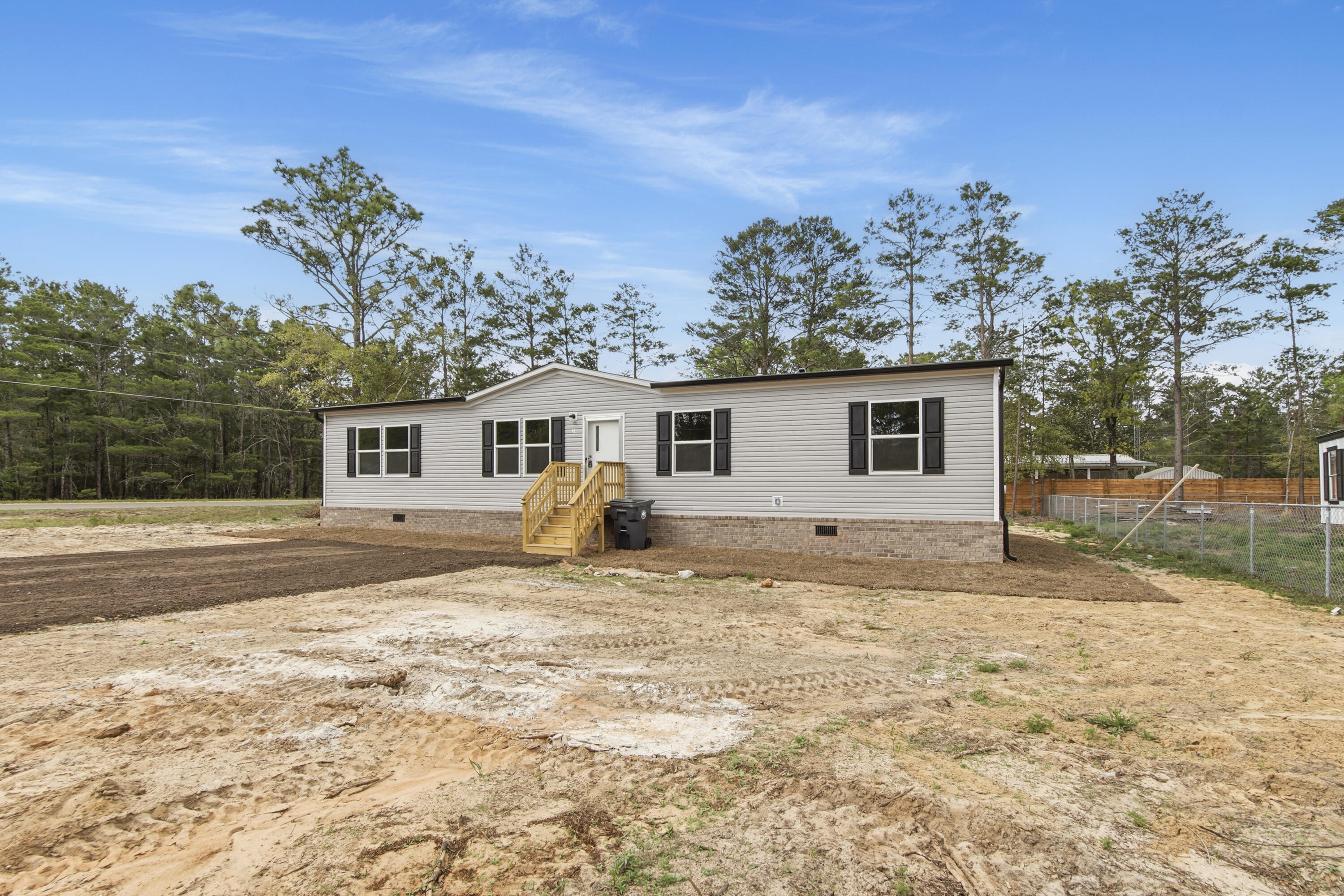 BRAND NEW construction home just completed at an accessible price point in DeFuniak Springs. Friendly floorplan allows for comfort and functionality. Featuring gutters, true brick skirting, and pilled pavement driveway, this home is upgraded from a lot model. Room sizes for allow for versatility for each family member to have their own space, for hobbies, or guests. Home is situated on a lot that is manageable, with NO HOA.