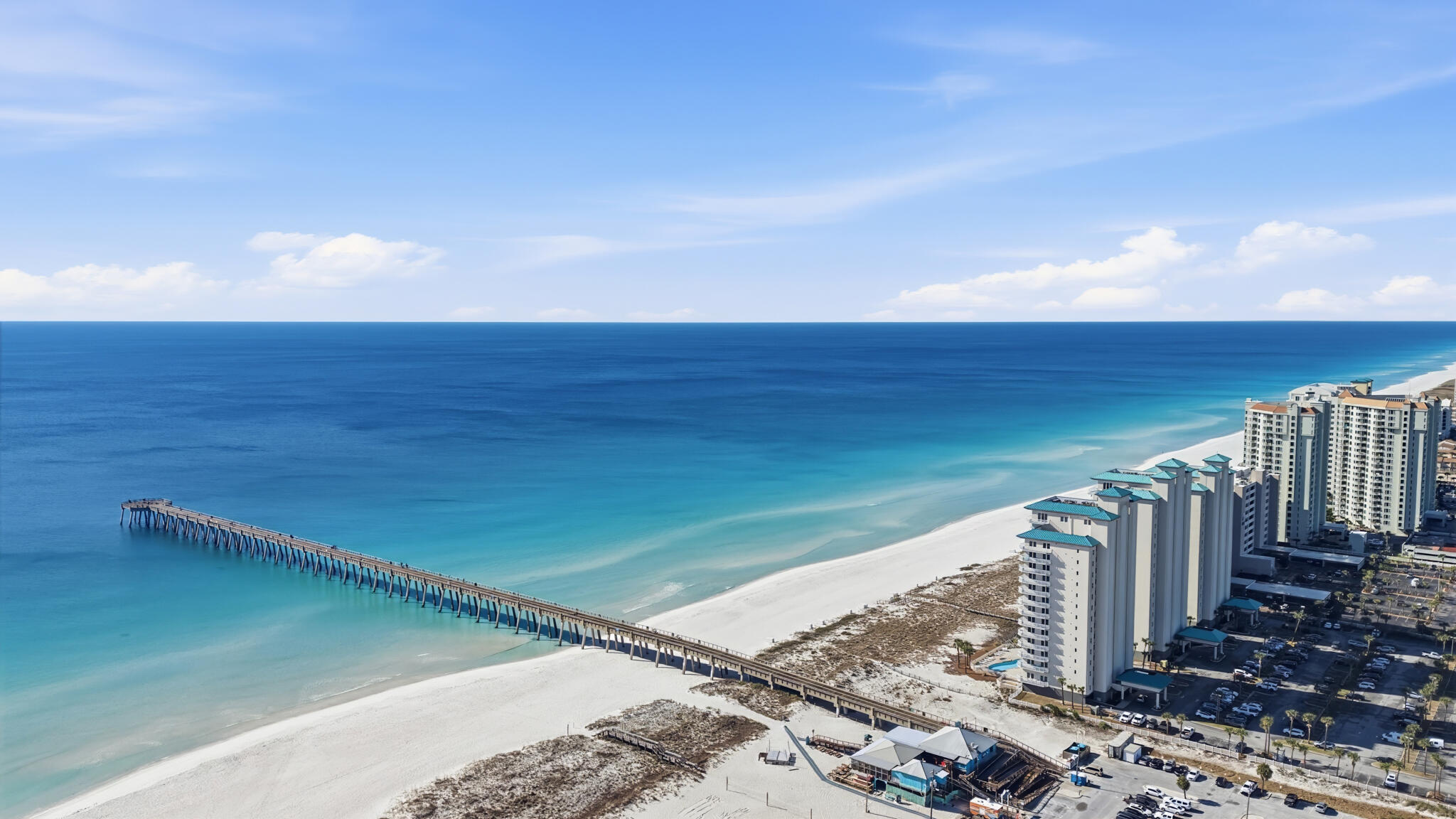 Experience the pinnacle of coastal luxury in this one-of-a-kind Penthouse, occupying the entire 15th floor of The Inn at Summerwind Resort on Navarre Beach. This sprawling estate was masterfully reimagined and remodeled by the owners to create a private sanctuary high above the Emerald Coast. Located at the most convenient point on Navarre Beach, you are steps away from the Navarre Pier and local restaurants, with the easiest access to the causeway for off-island travel. Beginning at the elevator, a private code whisks you directly to your own enclosed entranceway - adding an extra level of privacy. This residence offers 3 bedrooms and 3 full bathrooms. With elegant touches throughout - such as tray ceilings and crown molding. The first bedroom has 2 new twin beds, a new Samsung TV, and an en-suite bathroom that is shared with the media room. Across the hall is the laundry room. You can enter the second bedroom and its closet through here or from its own door off the media room. This bedroom has 2 queen sized beds, a matching furniture set with plenty of drawer space, a desk area, and a new Samsung Smart TV. The media room also has a new 70'' Samsung TV and one of the sofas is a pull out bed. From there, you can enter the kitchen, living room, or dining area. Surrounded by floor-to-ceiling windows and 3 sets of slider doors to the wrap-around, private, rooftop balcony for the most amazing views of the sparkling Emerald waters of Navarre Beach and a true extension of your living space. The West side featuring an oversized patio for outdoor dining and entertaining. The kitchen is a chef and entertainer's dream, with a bar area, wine fridge, ice maker, double wall ovens, glass cooktop, a matching cabinet front Over Under Sub-Zero Refrigerator, dishwasher with matching cabinet front, granite countertops, and plenty of cabinets. The primary suite offers a new Stearns & Fosters King Mattress and new headboard, a beverage fridge, 2 sets of slider doors leading to the wrap around balcony - 1 oceanfront and 1 to the East, an oversized closet, and the most amazing spa-like en-suite bathroom - complete with dual vanities, walk-in shower, and a jetted tub with a view of the Gulf. This Penthouse also comes with 2 highly coveted, covered & deeded parking spaces and has been owner occupied since purchased in 2004. Featuring 2 new HVAC units and a 2024 80 gallon commercial Rheem Water Heater for peace of mind. Schedule your private showing today, and start living the high life on Navarre Beach!