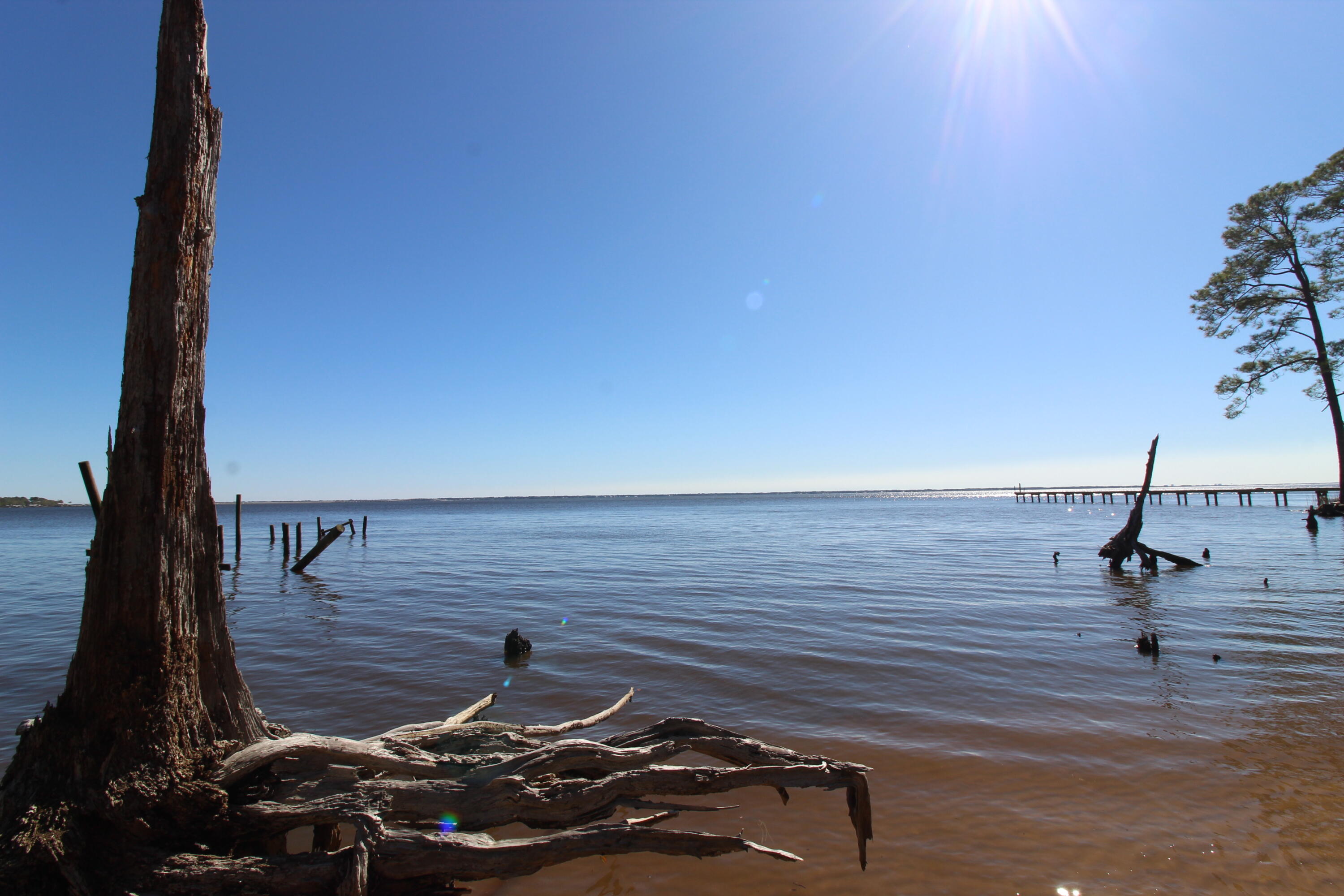 Skip the Red Tape, Start Building Now!  Imagine waking up to breathtaking panoramic views of the shimmering Choctawhatchee Bay. This is your opportunity to start building on two lots in Freeport Florida. And this is where the magic truly lies: a transferable Florida Department of Environmental Protection (FDEP) permit is already in hand! Say goodbye to the frustrating and time-consuming process of obtaining permits, which can easily take 18 months and incur significant costs. You're ready to bring your dream home to life immediately, saving you valuable time and money. 120 feet of pristine bay frontage to enjoy unparalleled water views and direct access to the Choctawhatchee Bay and a few nautical miles to the Intracoastal Waterway. Nestled away from the hustle and bustle, LaGrange Bayou