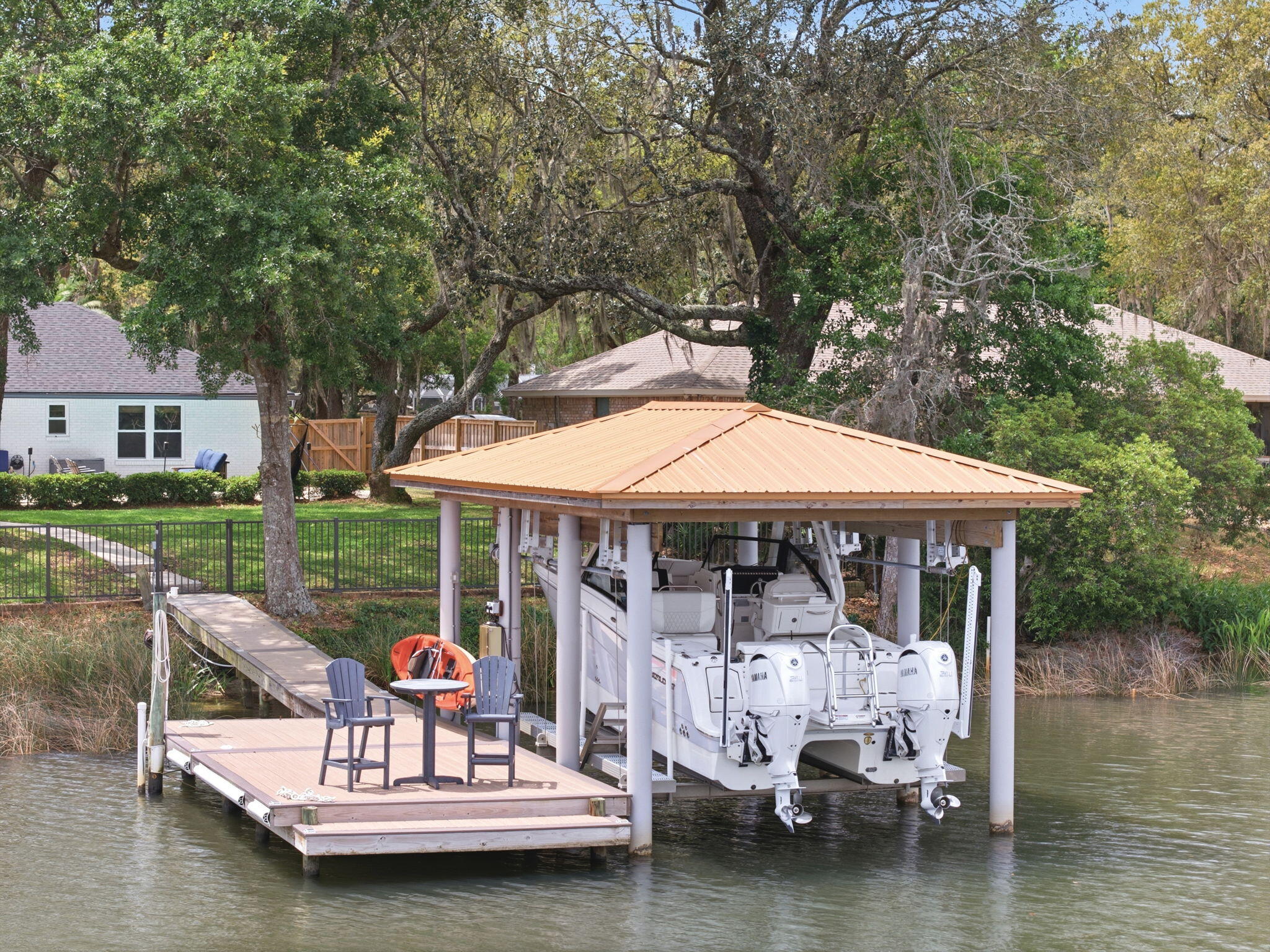 Tucked beneath a canopy of mature oak trees along the peaceful Bay location - this extraordinary waterfront residence is the definition of refined coastal living--where thoughtful design meets uncompromising quality and every detail has already been elevated for the next owner.

From the moment you arrive, the presence is undeniable. A newly completed driveway, sidewalk, and dedicated boat trailer parking pad (2023) set the tone, while the exterior showcases durable James Hardie board siding (2021), new gutters (2022), and a 30-year architectural roof (2022). Step inside and you'll immediately feel the care and craftsmanship poured into this home--every interior door, trim piece, and hardware selection has been completely updated, creating a cohesive and elevated aesthetic throughout. The heart of the home is a fully reimagined kitchen, taken down to the studs and expanded in 2022 to create a true gathering space. Outfitted with premium GE Café appliances, a Silgranite sink, soft-close cabinetry, granite surfaces, and stunning shiplap ceilings, this space seamlessly connects to a walk-in pantry and thoughtfully designed office (or optional 5th bedroom) with its own walk-in closet. The adjacent laundry room was also relocated and redesigned for maximum functionality.

Designed with flexibility in mind, the home features two luxurious primary suites--including a private upstairs retreat added in 2022 above the newly constructed garage. This suite is a sanctuary of its own, complete with a dedicated HVAC system, 50-gallon water heater, and the ability to be fully isolated from the rest of the home--perfect for guests, multigenerational living, or ultimate privacy.

Step outside and experience true waterfront living. The backyard is fully fenced (2025) with convenient dog door access, leading you to a beautifully maintained outdoor space complete with a resurfaced pool (2025), upgraded multi-stage pump, and saltwater system (2022). The composite dock (2021) and professionally constructed boathouse by Northwest Marine (2022) are nothing short of exceptional--featuring ECO piles, power and water, and a 12,000 lb lift, all set on deep water capable of accommodating larger vessels. This is a rare opportunity for boating enthusiasts seeking both function and durability.

Every major system in this home has been addressed with intention and longevity in mind. Highlights include:

High-impact hurricane windows (2022)
Complete HVAC replacement with insulated ductwork to current code (2022)
Additional 100-amp electrical service, new panels, and EV charging readiness in the garage (2022)
Full PEX plumbing conversion and new water main with protective sleeve (2022)
Whole-home water filtration system (2022)
R38 blown-in insulation for enhanced efficiency
4-zone irrigation system with private well
Additional recent updates include fresh carpet (2026), updated secondary bathroom fixtures (2026), regrouted shower (2026), upgraded sunroom ceiling (2025), and continued pest protection with a transferable termite bond through Arrow Exterminators.

Beyond the home itself, the location is equally compelling. Centrally positioned for easy access to Pensacola, Fort Walton Beach, and Highway 87 for quick interstate travel--this property offers both convenience and tranquility. With no HOA, a setting rich in natural beauty, and deep-water access that's increasingly difficult to find, this is truly a standout offering along the Emerald Coast.

This is more than a home--it's a meticulously upgraded waterfront retreat where every improvement has already been made, allowing you to simply arrive, exhale, and enjoy the lifestyle.