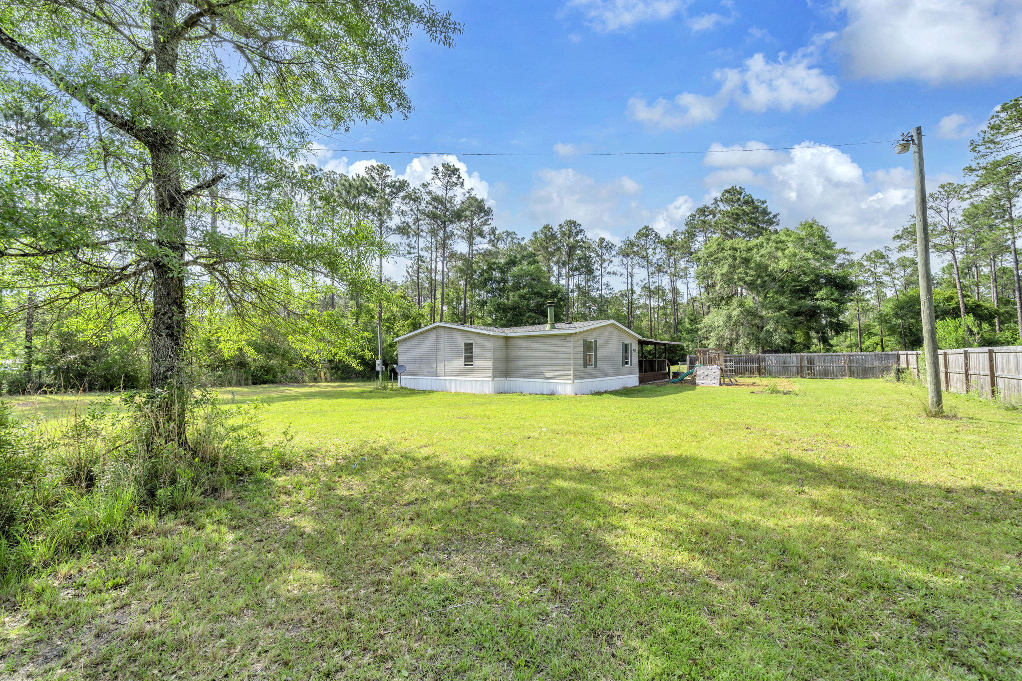 Welcome to the kind of property that's getting harder and harder to find in Freeport. Nearly a full acre of fully fenced land, no HOA, and the freedom to truly enjoy your space without restrictions or extra fees.

Whether you have a boat, RV, work trailers, toys, or simply want room to spread out, this property delivers with double-gate rear access and plenty of usable outdoor space. Privacy and convenience all come together here in one incredible setting.

Location is another major advantage. Skip the Highway 20 traffic and enjoy quick access to everything the Emerald Coast lifestyle has to offer. You're just 5 minutes to Grady Brown Park with bay access, less than 20 minutes to the white sand beaches and shopping of 30A, and only 6 minutes north to Publix, restaurants, gyms, and everyday conveniences.

Inside, this move-in ready 4-bedroom, 2-bath home offers comfortable living with major system updates already completed for peace of mind, including a roof less than one year old, plus updated A/C, water heater, and plumbing all within the past five years. The private well and septic system also help keep monthly utility costs low with no city water bill.

Whether you're searching for a primary residence, a second home, investment opportunity, or even a temporary place to live while building your dream home, this property offers flexibility that is hard to match at this price point.

Properties offering this much land, privacy, freedom, and convenience rarely come available!