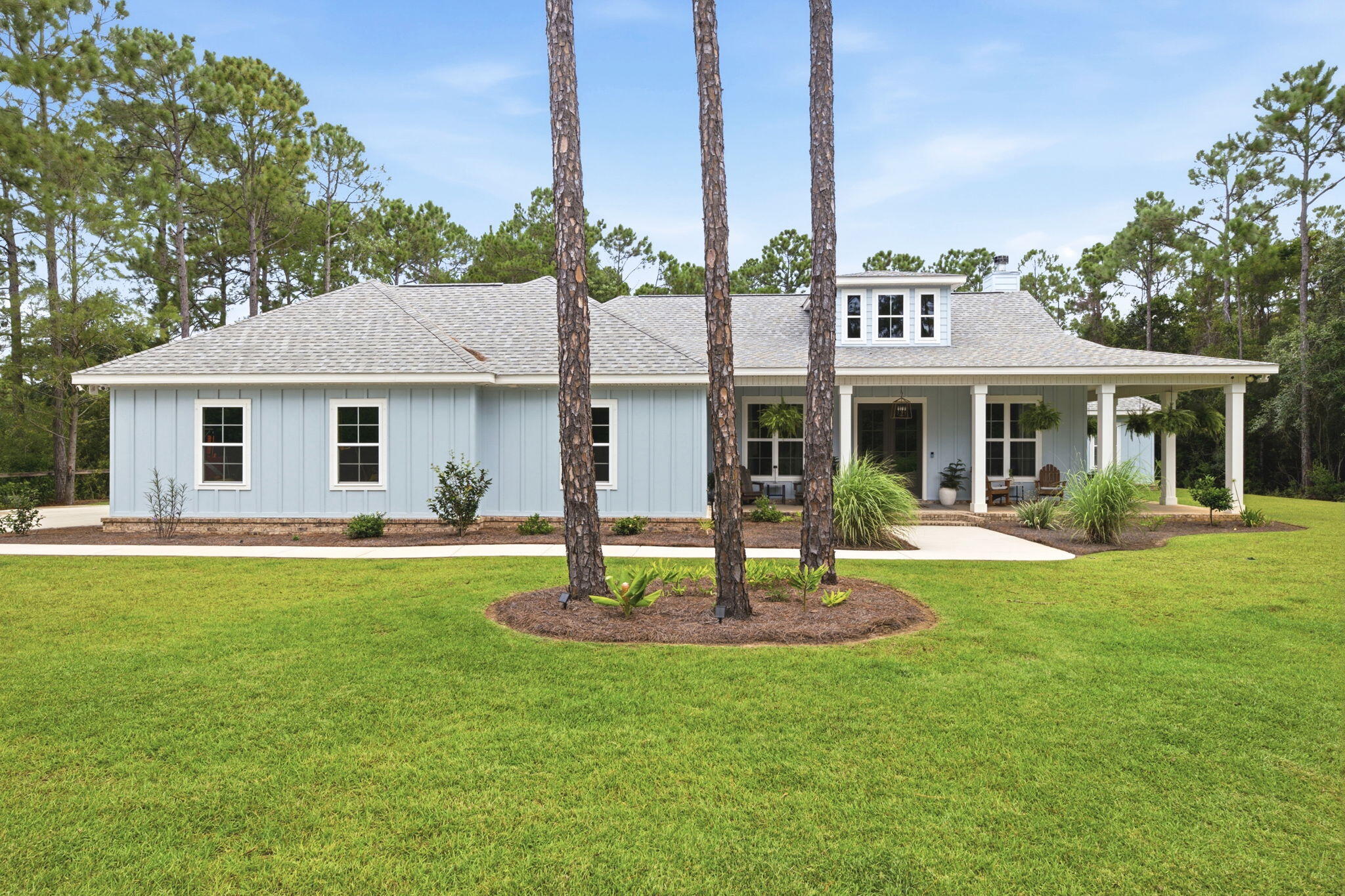 Nestled on 1.5 acres at the end of a quiet wooded dead-end road in Gulf Breeze, this inviting 4-bedroom, 3-bath custom home was thoughtfully built in 2024 by Cretin Townsend as an owner/builder design, showcasing quality construction and attention to detail. Step inside to an open-concept space designed for comfortable everyday living and entertaining. A cozy wood fireplace anchors the living area, which flows seamlessly into the bright kitchen and dining spaces. Large windows fill the home with natural light.

The well-appointed kitchen features granite countertops, soft-close cabinetry, GE Café Series appliances, generous workspace, a built-in media hub, and ample storage.

The primary suite offers a private retreat with an en-suite bath and large walk-in closet. Three additional bedrooms provide flexible space for guests, a home office, hobbies, or other needs, along with two additional full bathrooms.

Outside, enjoy the full wraparound front porch or spacious screened back porch overlooking the wooded acreage. These outdoor spaces offer room to relax and enjoy the natural surroundings. Built with custom upgrades throughout, this modern home blends comfort, quality, and privacy. Conveniently located minutes from Gulf Breeze, Pensacola Beach, Navarre Beach, shopping, dining, schools, and local amenities, this property offers a desirable combination of space, craftsmanship, and location.