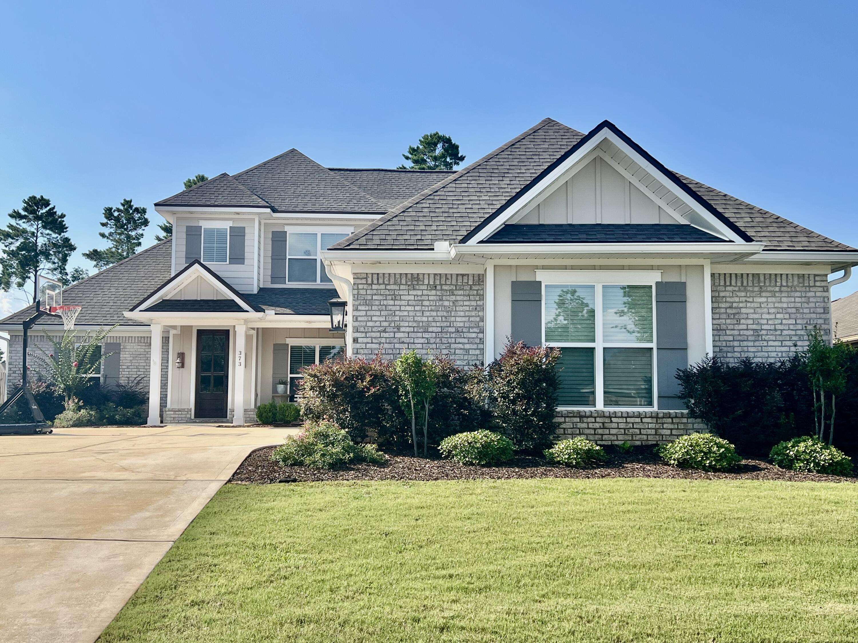 Impeccably maintained & completely move-in ready, this stunning Arlington floor plan offers an open-concept, split-bedroom design with exceptional upgrades throughout. This beautiful all-brick home with Hardie accents features luxury LVP flooring and tile throughout--no carpet! The chef's kitchen boasts quartz countertops, a gas cooktop, wall oven, stainless steel appliances, an oversized breakfast bar, abundant white cabinetry with designer hardware, and wood shelving in the pantry. The spacious family room features a gas fireplace & expansive windows overlooking the backyard, while the dining area flows seamlessly into the living space. Elegant trim around the windows and doors, decorative staircase, tiled showers, a smart home package, Rinnai tankless water heater, mudroom, large laundry room with utility sink, & an oversized 3-car garage complete the main living areas. The first-floor primary suite offers backyard views, a spa-inspired bath with a tiled shower, soaking tub, dual vanities, and a large walk-in closet. A second main-level bedroom and full bath provide the perfect space for guests, a home office, or flex room. Upstairs you'll find a versatile loft, two spacious bedrooms with walk-in closets, a bonus study nook, and walk-in attic storage with flooring already in place. Relax on the covered back porch (with gas hook up for grill) overlooking the oversized backyard with plenty of room for a future pool. Resort Style amenities in Hammock Bay Community.