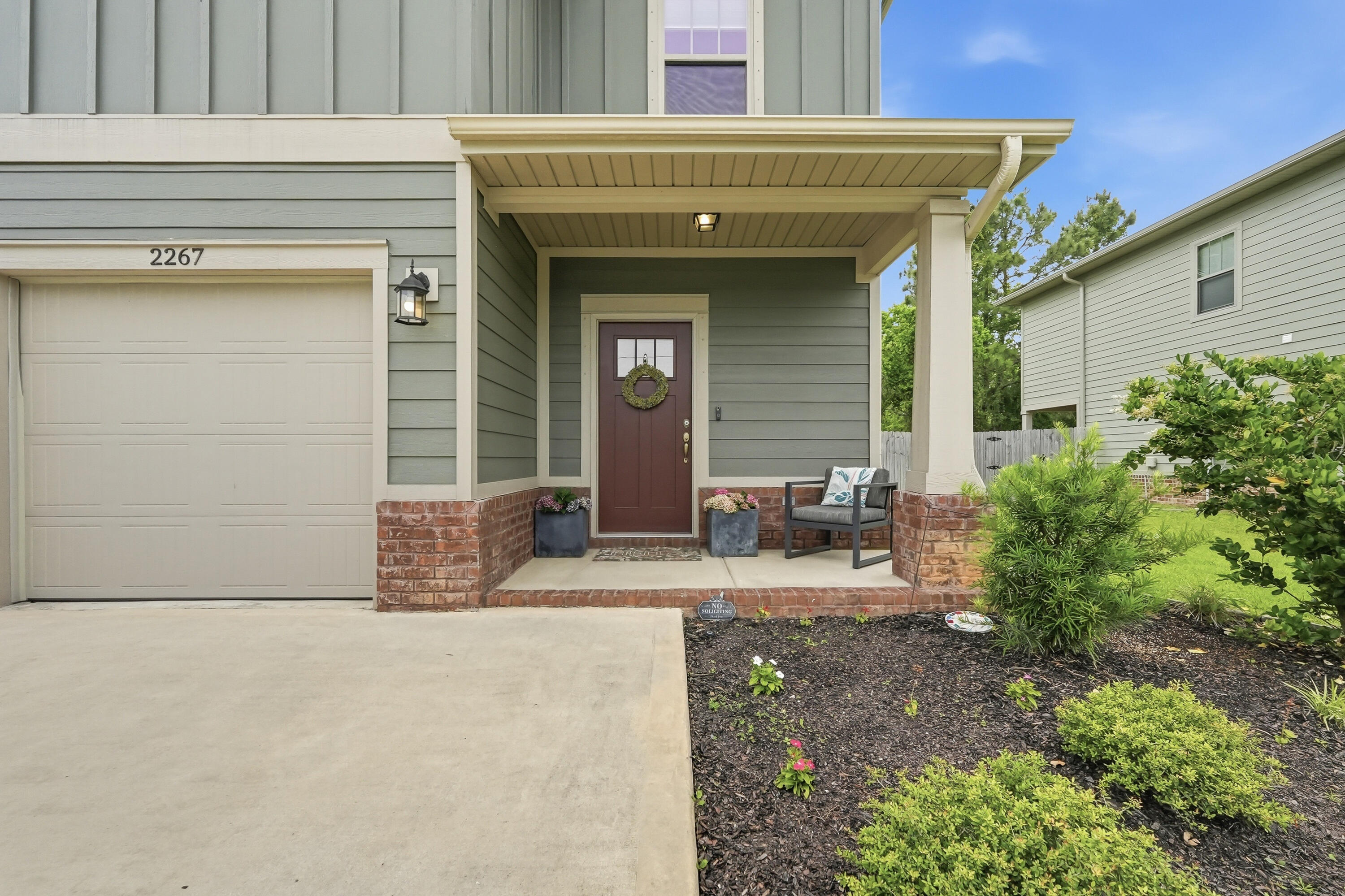 This home is located within minutes from Hurlburt Field in East Navarre! This exceptional move-in ready two-story residence is like-new, just four years old! Showcasing thoughtful design inside and out, the exterior features cement fiber board siding complemented by timeless brick accents, an irrigation system, rain gutters, a fully fenced backyard for added privacy and a large, covered patio. Inside, the home offers luxury vinyl plank flooring throughout the main living areas on the first floor, elegant neutral tile in the bathrooms, and comfortable carpeting in the bedrooms. Additional features in this open concept plan include a welcoming entryway with transom accent window, coat closet, guest half-bath, tall ceilings, wide baseboards, crown molding, and a dedicated dining area. The beautifully appointed kitchen is complete with stainless steel appliances, tile backsplash, shaker-style soft close cabinetry, granite countertops, a walk-in pantry and an oversized island with pendant lights and breakfast bar seating. VA assumable loan for qualified buyer! This home has it all!