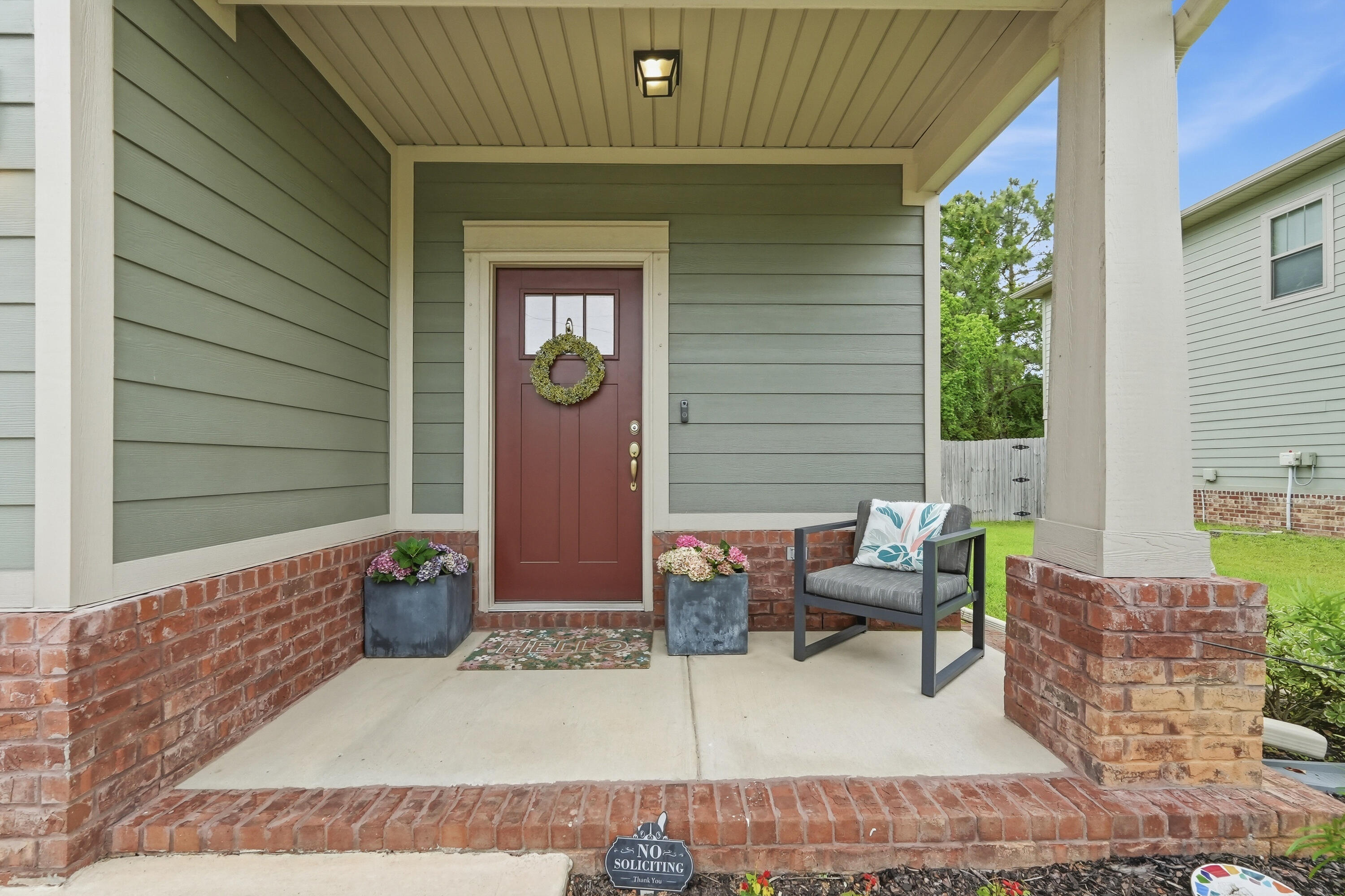Skip the traffic - Your commute to Hurlburt Field or Ft. Walton Beach is just MINUTES! VA assumable loan for qualified buyer! Located in East Navarre, this exceptional move-in ready two-story residence is like-new, just four years old! Showcasing thoughtful design inside and out, the exterior features cement fiber board siding complemented by timeless brick accents, an irrigation system, rain gutters, a fully fenced backyard for added privacy and a large, covered patio. Inside, the home offers luxury vinyl plank flooring throughout the main living areas on the first floor, elegant neutral tile in the bathrooms, and comfortable carpeting in the bedrooms. Additional features in this open concept plan include a welcoming entryway with transom accent window, coat closet, guest half-bath, tall ceilings, wide baseboards, crown molding, and a dedicated dining area. The beautifully appointed kitchen is complete with stainless steel appliances, tile backsplash, shaker-style soft close cabinetry, granite countertops, a walk-in pantry and an oversized island with pendant lights and breakfast bar seating. This home has it all!