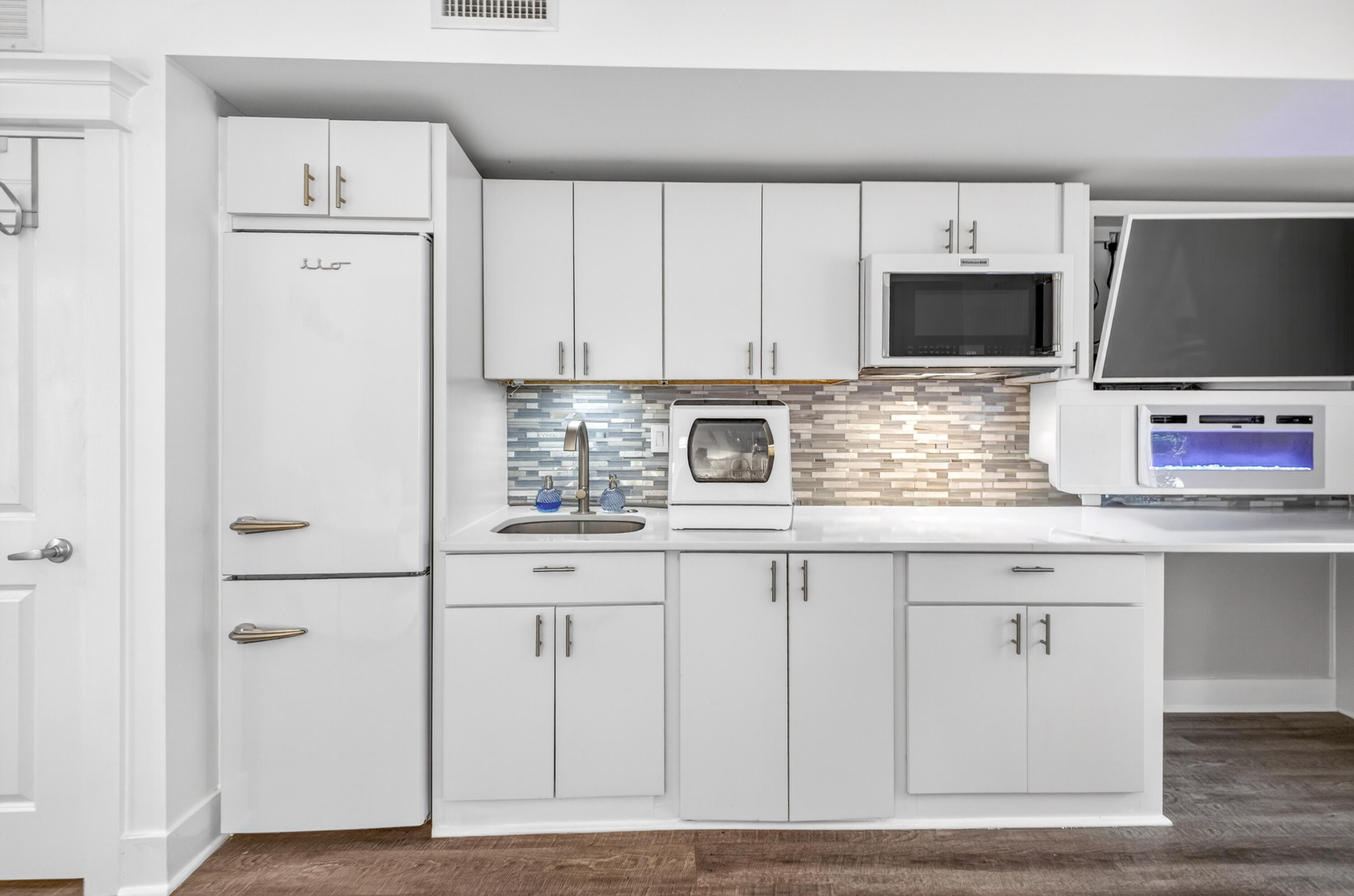Experience effortless coastal living in this beautifully renovated first floor studio-an exceptional opportunity for both personal use and investment. Thoughtfully redesigned from top to bottom, this space blends style, comfort, and functionality with elevated, high-end finishes throughout. The custom kitchen is a true standout, featuring sleek cabinetry, Silestone countertops with a breakfast bar, and a stylish tile backsplash. High-end appliances include a KitchenAid convection microwave oven with built-in exhaust ventilation above a two-burner ceramic induction cooktop, a large apartment-size Retro iio refrigerator/freezer, and a convenient countertop dishwasher. Under cabinet lighting and a large sink with a new high-end faucet and disposal adds everyday convenience. 

The open living area is designed for both relaxation and style, complete with a high-end Samsung tv, recessed, Framed, with separate box called the One Connect with sound system, ambient mood lighting, and a modern electric fireplace with heat perfect for cozy evenings. Hunter Douglas automatic shades and contemporary ceiling fans add a refined touch throughout the space.

The spa-inspired bathroom offers a serene escape with a new vanity, rain showerhead, designer tile accents, updated fixtures, and a space-saving smoked glass / wood barn door. A lighted medicine cabinet and elegant lighting complete the polished look.

Additional upgrades include luxury vinyl plank flooring throughout, a GE ventless washer/dryer combo, HVAC replaced in 2022, water heater replaced in 2024, and fresh interior paint. The building is also equipped with a Halo water detection system, providing added peace of mind.

Includes large patio with beautiful, relaxing view of perfectly manicured grounds, including live oaks, evergreen forests, and freshly planted seasonal flower gardens.  Patio located on tree lined wide, paved walking path.  Short distance to breakfast cafes, ice cream shops, and many, great restaurants with nightly live music, and a long peer over the Bay for fishing or watching the sunset.  Sandestin's private beautiful beaches are a short bike ride or golf cart ride away, and golf courses are a quick golf court ride away.  Pickle ball courts and marina are also a short distance away.

Ideally situated on the first floor for easy access, this studio perfectly captures the balance of modern comfort and coastal charm. A rare find that must be seen to be fully appreciated.

As an introduction to the Sandestin lifestyle, we invite our new owners to explore amenities that make Sandestin special. The listing brokerage and seller(s) are presenting the buyer(s) of this property with (2) 90-minute rounds of Tennis court time, a golf foursome at one of our three championship courses, and a round of golf for up to four (4) players at the unrivaled Burnt Pine Golf Club.

Sandestin Golf and Beach Resort features more than seven miles of beaches and pristine bay front, four championship golf courses, 15 world-class tennis courts, a 226-slip marina, a fitness center, spa and celebrity chef dining. Shop, dine and play at the charming pedestrian village, The Village of Baytowne Wharf and more. Inside the gates of the resort, residents enjoy a balanced lifestyle of high-class living, spanning the 2,400 acres from the beach to the bay. Everything within the gates of the resort is accessible by golf cart or bicycle. The entire resort is interconnected by miles of pedestrian, bike and golf cart paths that weave through groves of live oaks, meandering past natural lagoons, fountains, man-made lakes, and meticulously landscaped fairways.