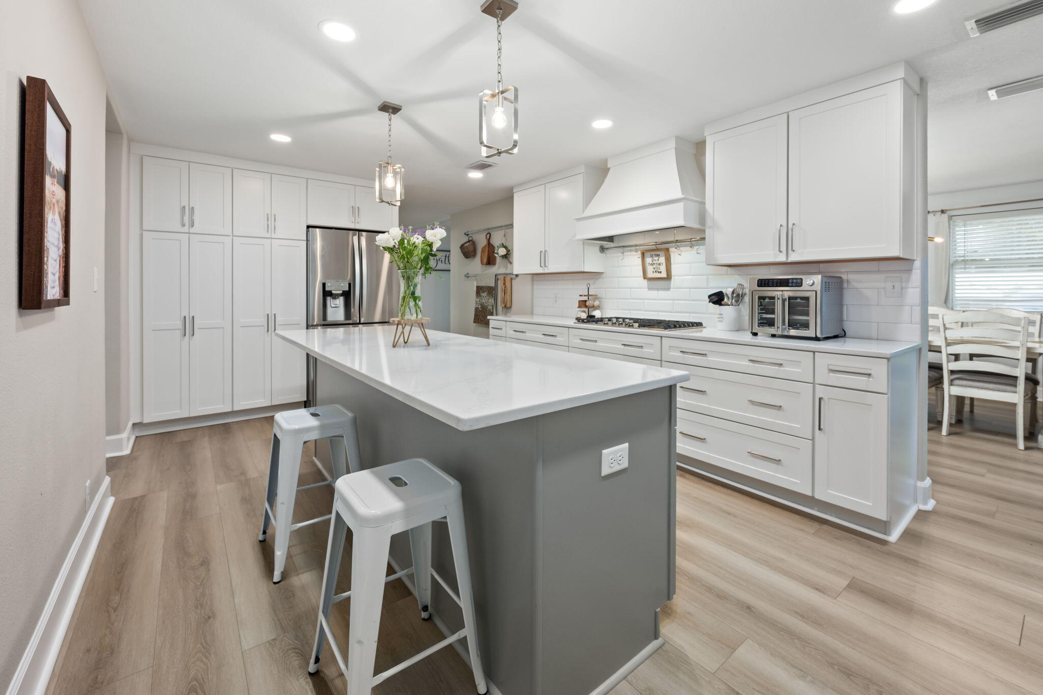 Nestled in the heart of Valparaiso, this 6 bedroom 3 bath gem has been thoughtfully upgraded to provide modern convenience.
As you pull up, you'll love the oversized circular driveway, offering plenty of parking space. 

Step inside to find a chef's dream kitchen! Featuring quartz countertops, custom shaker cabinets, and stainless steel appliances. The gas stovetop and double oven make preparing meals a breeze, while the massive center island provides ample prep space and extra storage. 
This home boasts an open and airy layout with a seamless flow between the kitchen, dining, and living spaces. The main living area features tile flooring, neutral tones, and large windows that flood the space with natural light.