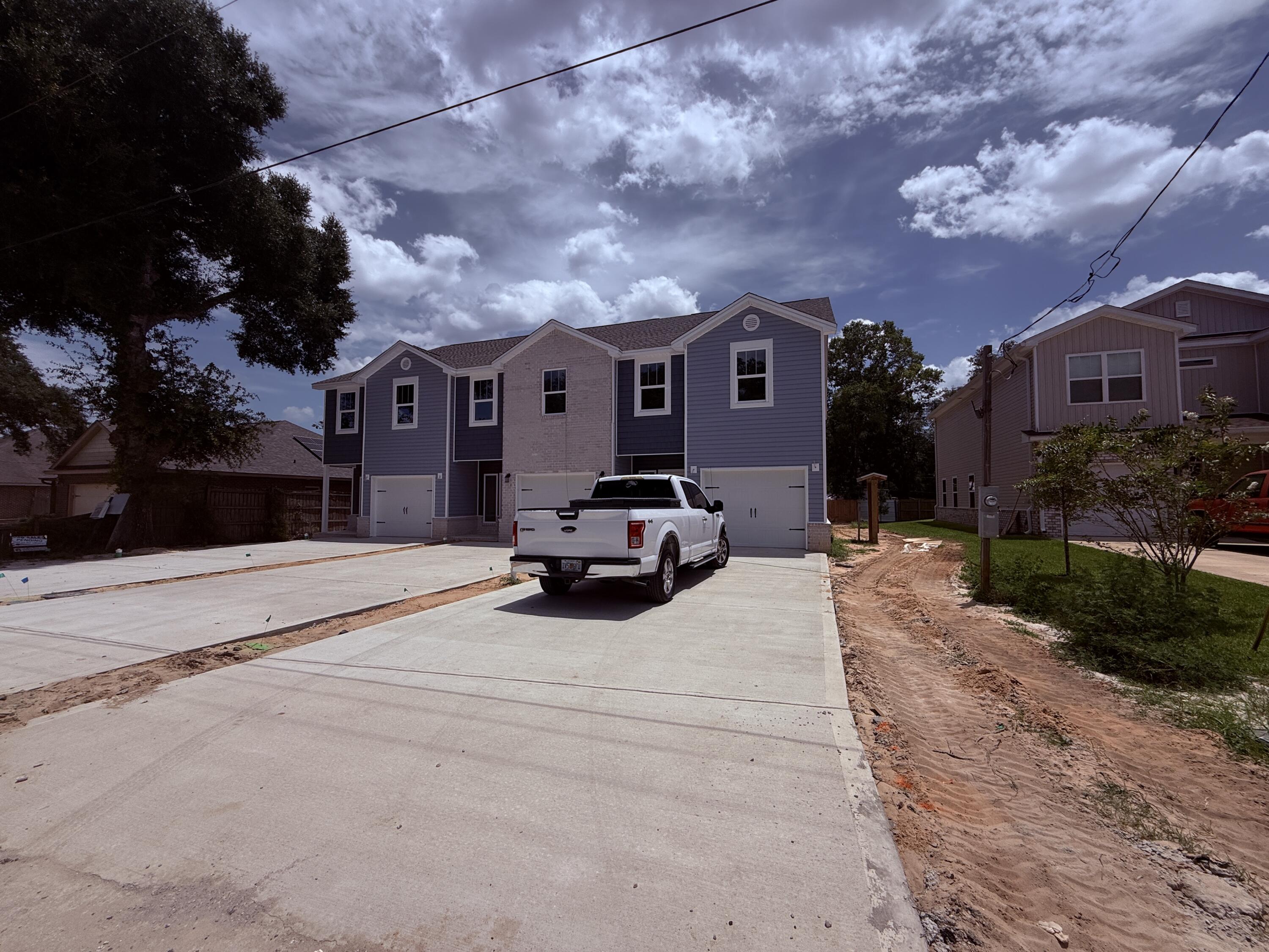 BRAND NEW END-UNIT townhome conveniently close to Bases, Beaches & Shopping! 3 bedrooms, 2.5 baths and 1,517 square feet of beautifully designed living space with NO HOA!  Builder is offering $12,000 in ''ANY WAY'' money that can be used toward closing costs and/or an interest rate buy-down! Built with impact glass windows for added storm protection and potential insurance savings, this spacious open-concept home features a large living and dining area, attached 1-car garage, half bath, and a stylish kitchen complete with stunning quartz countertops, stainless steel appliances including a refrigerator with ice maker, smooth-top range, built-in microwave, quiet dishwasher, breakfast bar seating, and dining area. Upstairs you'll find a generous primary suite with private sitting area, walk-in closet, and en-suite bath, along with two additional bedrooms, a full guest bath, and convenient upstairs laundry. Washer and dryer are included! Luxury Vinyl Plank flooring throughout except the two guest bedrooms and the stairway. Tile in the bathrooms.  Relax and entertain on the back patio overlooking the large 134-foot-deep Privacy Fenced backyard. Thoughtfully designed with comfortable room sizes, great storage, and modern finishes throughout--call today to schedule your private showing!  Projected completion is the end of July. ROOM SIZES ARE APPROXIMATE