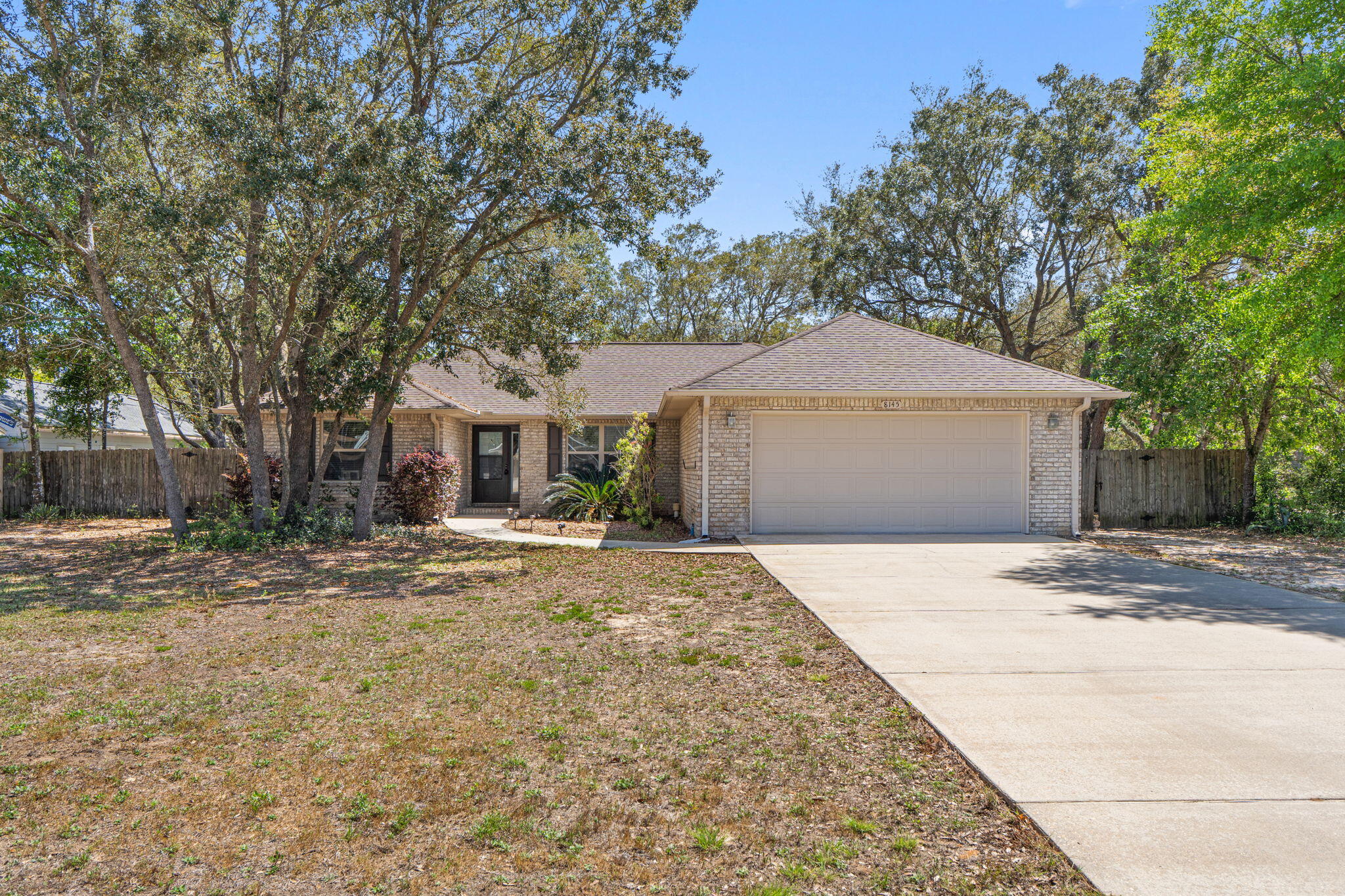 Kick out clause in place with home sale contingency. Back up offers welcome! Welcome home to one of Navarre's best-kept secrets! A beautifully updated retreat tucked beneath a canopy of mature trees on over half an acre of your own private slice of Florida. No HOA. No restrictions, just the natural, laid-back lifestyle you've been searching for. Perfectly positioned in the heart of Navarre, you're just minutes from the sugar-white sands of Navarre Beach, a short drive to Hurlburt Field, and close to top-rated schools, shopping, dining, and everyday conveniences. Location doesn't get much better than this. Step inside and feel the difference. Fresh paint throughout gives the entire home a crisp, move-in-ready feel, while the spacious open living area flows naturally  and invites you to settle in and stay a while. The kitchen is where this home truly shines...granite countertops, stainless steel appliances, and a breakfast bar that makes morning coffee feel like a treat. As well as the Culligan whole-house water filtration system plus reverse osmosis at the kitchen sink, means clean, great-tasting water throughout. Meal prep, entertaining, or just a quiet weeknight dinner; this kitchen handles it all in style.

Three comfortable bedrooms plus a huge bonus room offer all the space your lifestyle demands. Use the bonus as a fourth bedroom, home office, playroom, or gym, the choice is yours! The master suite is your personal sanctuary, complete with double vanities, a large soaking tub for unwinding after a long day, and a separate shower. The oversized, extra-deep two-car garage adds an additional 6 feet beyond standard depth. Perfect for a workshop, extra storage, or fitting that full-size truck with room to spare!

Outside, the property continues to impress. A screened patio and large extended concrete patio in the back create the ultimate outdoor living space, anchored by a cozy firepit that's perfect for cool Florida evenings. Privacy fencing, hurricane shutters, and gutters add peace of mind and year-round practicality all wrapped in the serene, wooded setting that makes this property feel like an escape every single day. Be sure and schedule your home tour before it's gone!