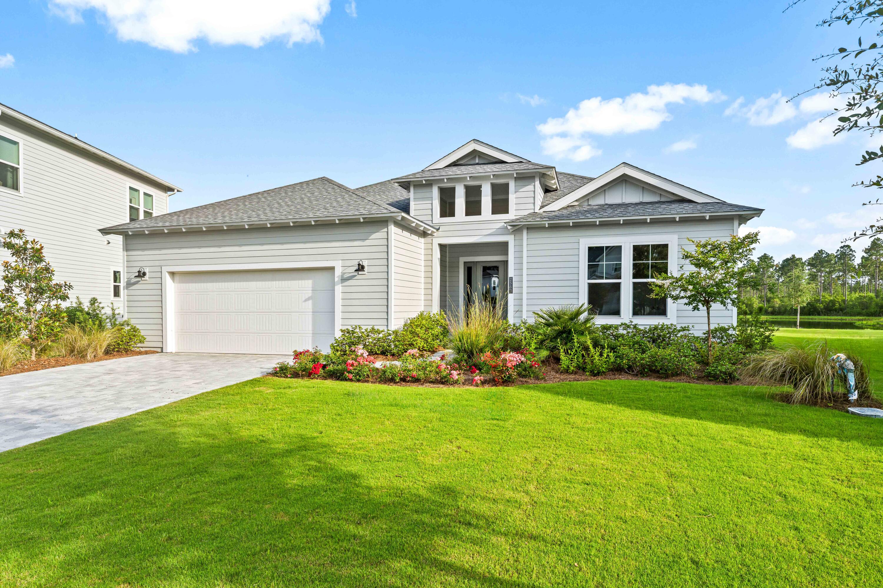 Brand-new 4-bedroom, 3-bathroom home in WaterSound Origins -- one of Scenic 30A's most celebrated gated communities in Inlet Beach, FL. This specially expanded new construction features soaring ceilings, rich engineered hardwood floors, and a chef's kitchen built for serious entertaining. The spa-inspired primary suite offers a luxurious walk-in shower and panoramic lake and nature preserve views. An oversized covered porch frames breathtaking Emerald Coast sunsets -- and the pool-ready lot means the backyard you've been imagining is entirely within reach. New construction quality. Gated community. Expanded floor plan. Lake views. This is the 30A address that checks every box. Minutes from Rosemary Beach, Alys Beach, Seaside, and the white sand beaches of South Walton County.
 Some homes check boxes. This one raises the bar. From the moment you step through the grand entry foyer, the difference is unmistakable -- soaring ceilings, rich engineered hardwood floors underfoot, and a level of finish that simply doesn't show up at this price point on Scenic 30A. The specially expanded floor plan lives larger than its footprint suggests, with a seamless flow from entry to living to dining that makes every gathering -- Sunday breakfast or a dinner party for twenty -- feel completely effortless.
The chef's kitchen is the undisputed heart of the home. Designed for real entertaining, it delivers the counter space, storage, and layout that weekend hosts dream about, without sacrificing the warmth and functionality that make everyday cooking a pleasure. Every finish, every fixture, every detail was chosen with intention -- craftsmanship you feel the moment you walk in and notice more the longer you stay.
The primary suite redefines what a bedroom can be on 30A. A true spa-inspired sanctuary with a luxurious walk-in shower, sleek rimless glass enclosure, dual vanities, and panoramic windows framing uninterrupted views of the lake and nature preserve. Wake up to that view every morning and the word 'ordinary' stops applying to your life. All three full bathrooms carry the same standard -- beautifully tiled, thoughtfully appointed, nothing left as an afterthought.
The outdoor setting is where this home becomes something else entirely. The oversized covered back porch was positioned perfectly -- lake views, nature preserve, towering longleaf pines, and those Emerald Coast sunsets that make people fall in love with 30A in the first place. The lot is generously sized with ample room for a custom pool, making this one of the few new construction homes in WaterSound Origins where the outdoor living potential is truly unrestricted. This is the backyard that 30A buyers spend years looking for.

Living in WaterSound Origins means resort-quality amenities come with the address. HOA membership covers access to multiple pools, a state-of-the-art fitness center, tennis courts, and pickleball courts -- and, perhaps most distinctively, the WaterSound Origins Golf Course, a beautifully designed par-3 layout winding through preserved wetlands and longleaf pine forest. Beyond that, dock access at Lake Powell -- one of Florida's rarest and largest coastal dune lakes -- miles of walking and biking trails, and the scenic Monarch Art Trail make the community itself a daily destination.
For residents who want to go further, an optional Watersound Club membership is available. The Watersound Beach Club offers over 1,000 feet of private Gulf-front beach with two zero-entry pools, poolside cabanas, and concierge-level service. The Camp Creek campus adds a 12,000-square-foot wellness and fitness center, three dining venues, resort pools, 8 Har-Tru clay tennis courts, and 8 pickleball courts. Golf access spans three championship courses: Camp Creek (Tom Fazio), Shark's Tooth (Greg Norman), and The Third. Ask your agent for current membership details.

Location is the third reason this home makes sense. Inlet Beach sits at the eastern gateway of Scenic Highway 30A, minutes from Rosemary Beach, Alys Beach, and Seacrest Beach -- with an easy bike or walk along the multi-use path to the Rosemary Beach farmers' market. Head west and the whole corridor opens up: Seaside, WaterColor, Seagrove Beach, Grayton Beach, Blue Mountain Beach. The Northwest Florida Beaches International Airport is 16 miles away -- a direct connection for buyers relocating from Atlanta, Nashville, Dallas, or Houston. Destin's harbor is a short drive west. Watersound Town Center -- Publix, Starbucks, restaurants, and medical -- is within walking distance. Everything you need, nothing in the way.