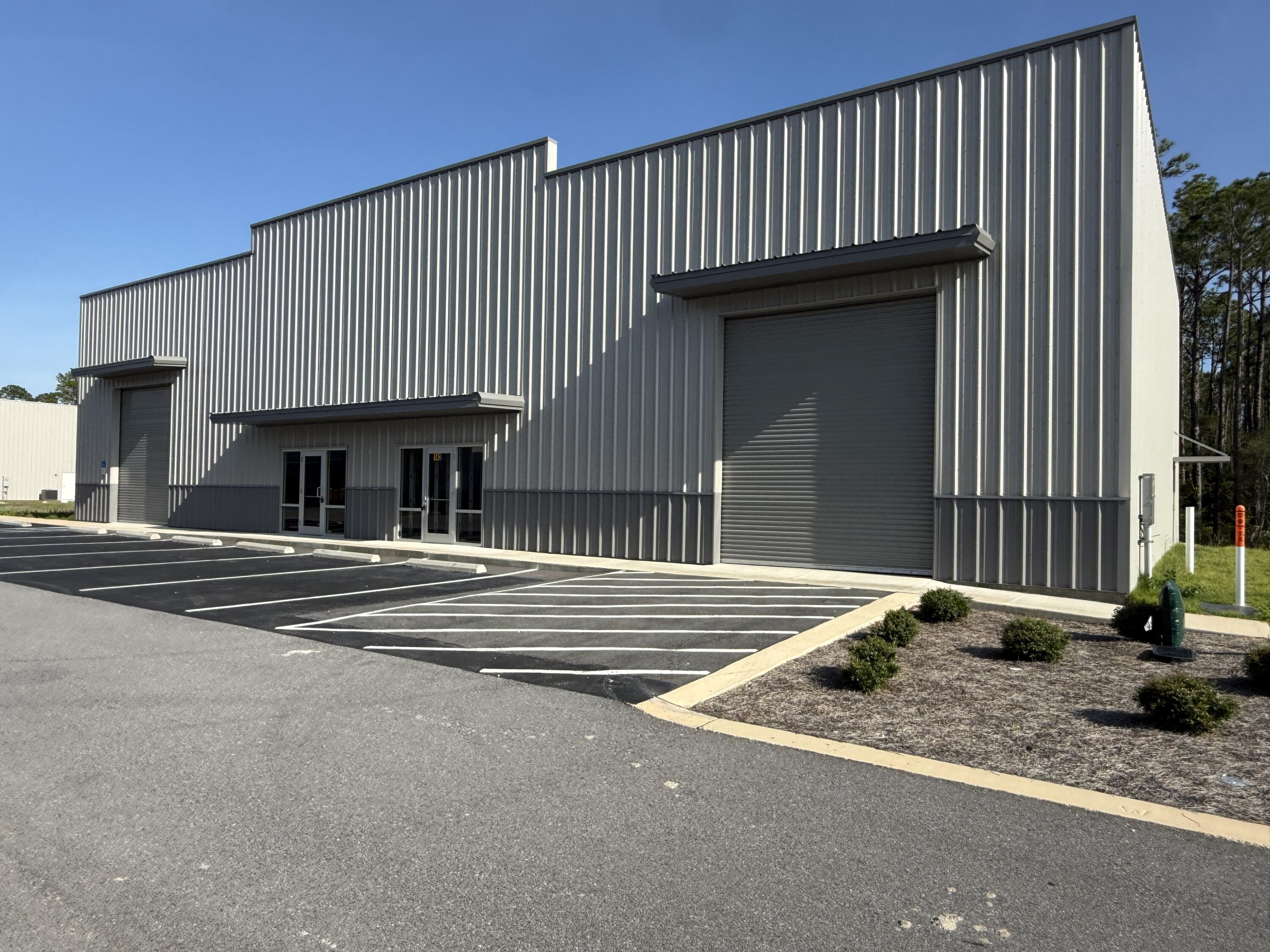 Only one bay remains in this brand-new freestanding flex building. This 3,000-square-foot space is one of only two units in the building, offering a rare opportunity to lease a clean, secure, newly constructed space. The unit features impressive 23' to 28' sloped ceilings, a 14-foot overhead door, and dedicated parking. Delivered as a shell, the space provides the flexibility to build out the interior to meet your specific needs. This final available bay offers the space, accessibility, and versatility you've been looking for.